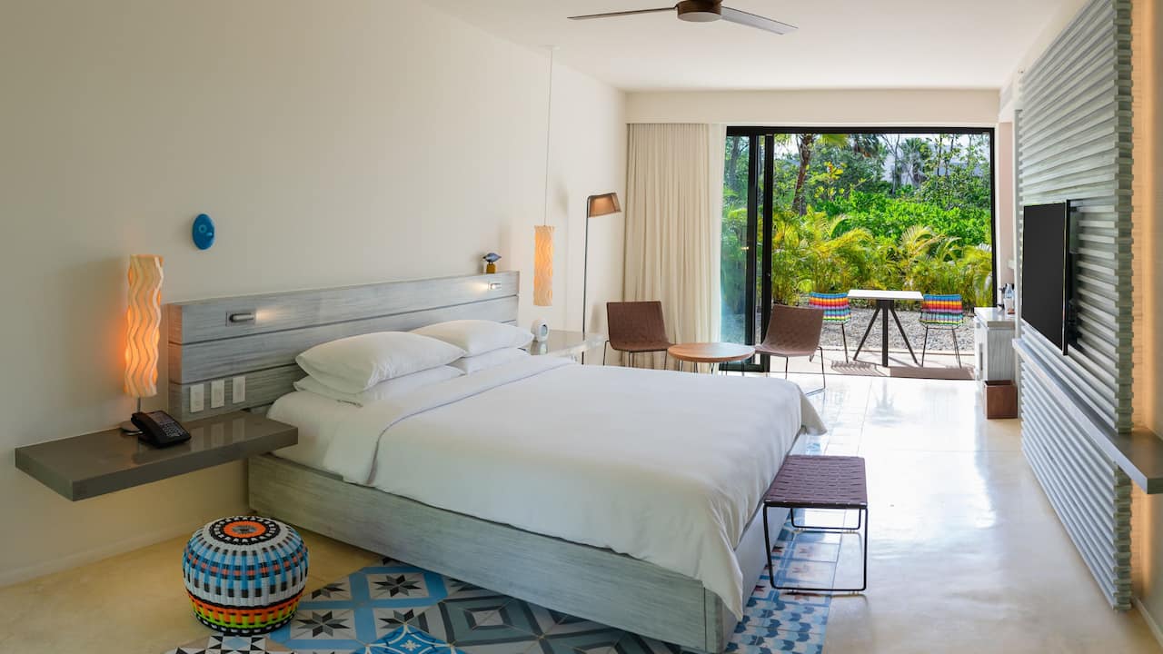 A standard king bed resort room with a private terrace located right outside of the balcony at Andaz Mayakoba Resort Riviera Maya