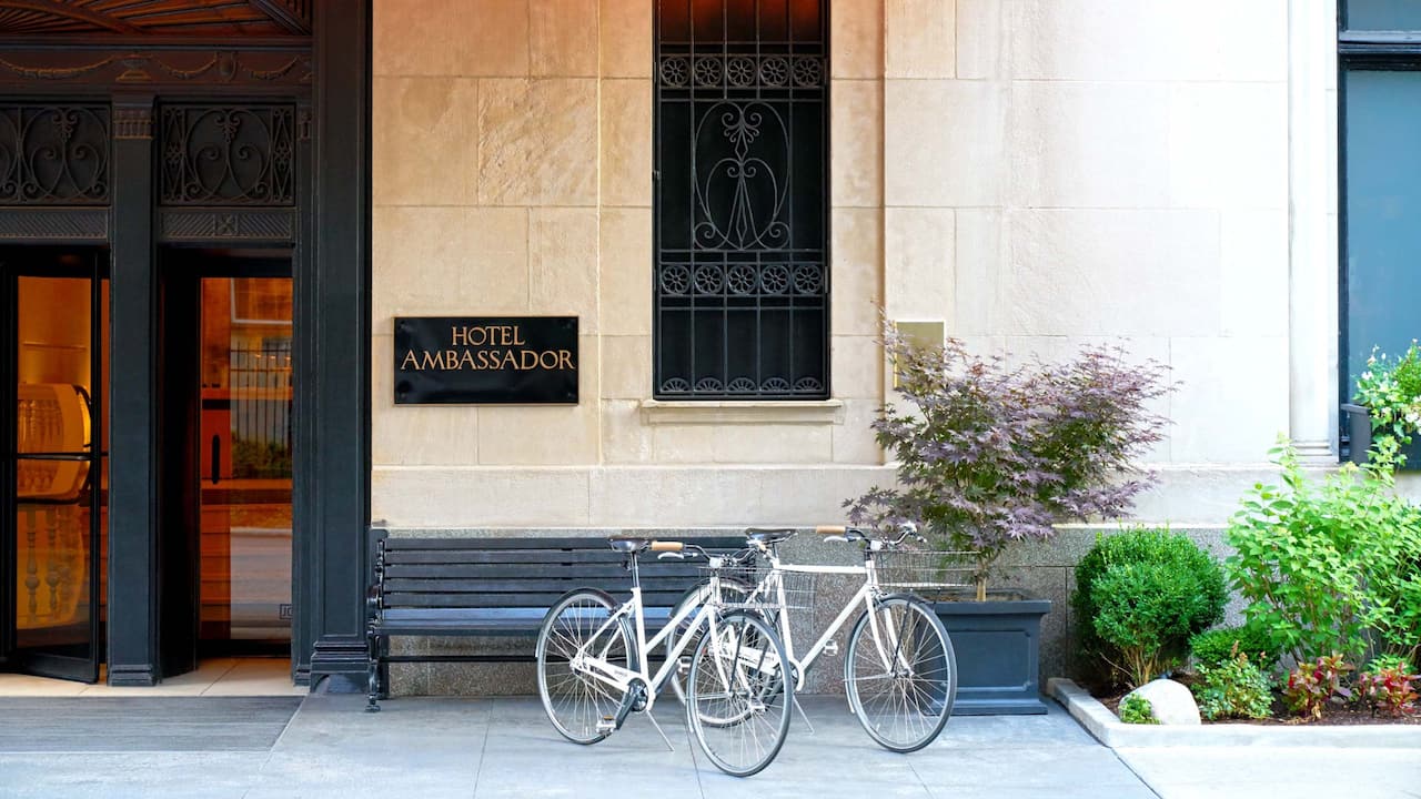 Hotel entrance with bikes parked in front at Ambassador Chicago