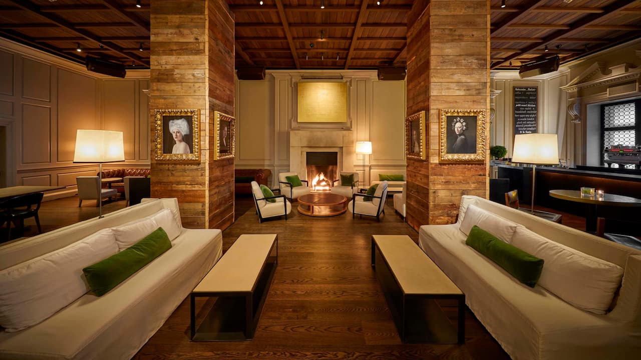 The Library seating area with hardwood floors and indoor fireplace