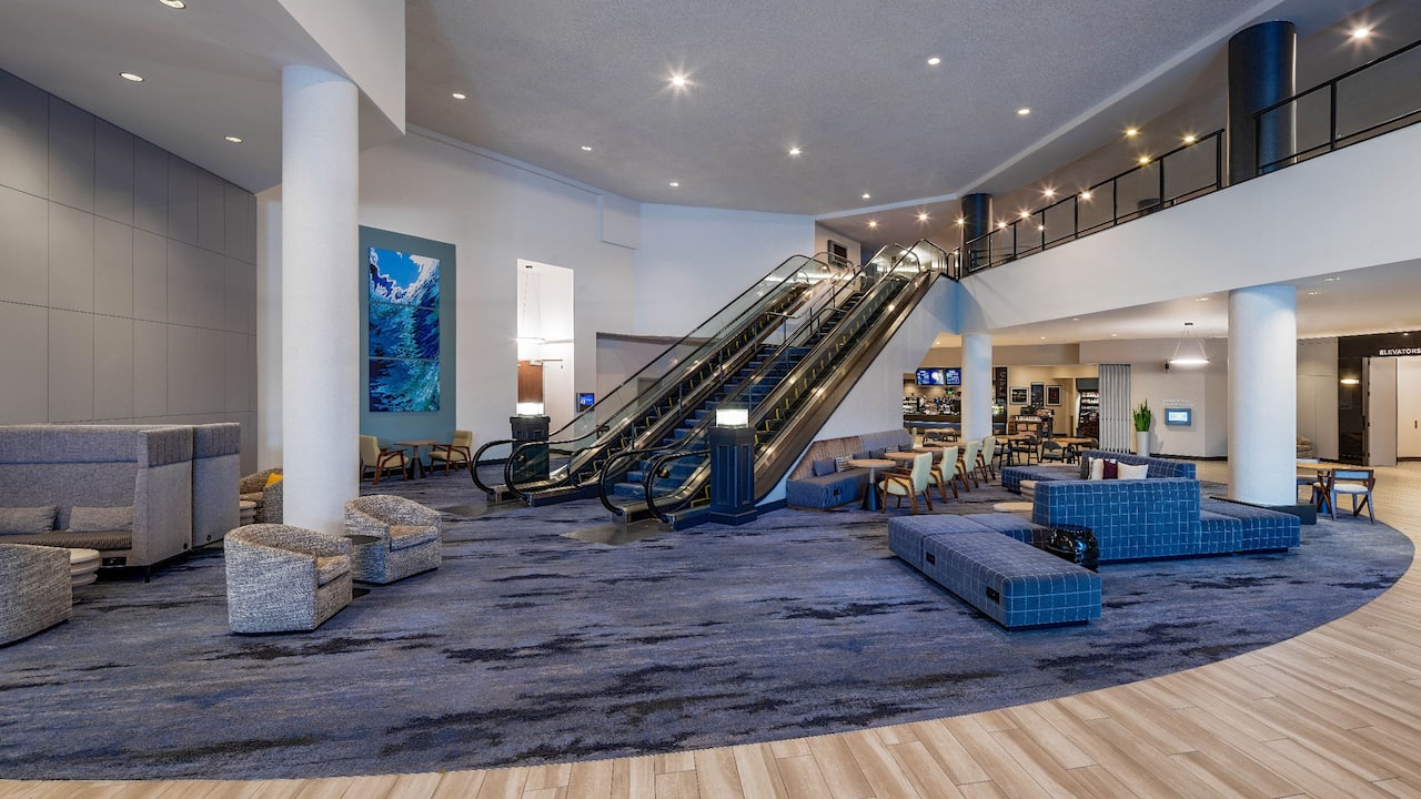 Lobby with spacious seating area and escalators