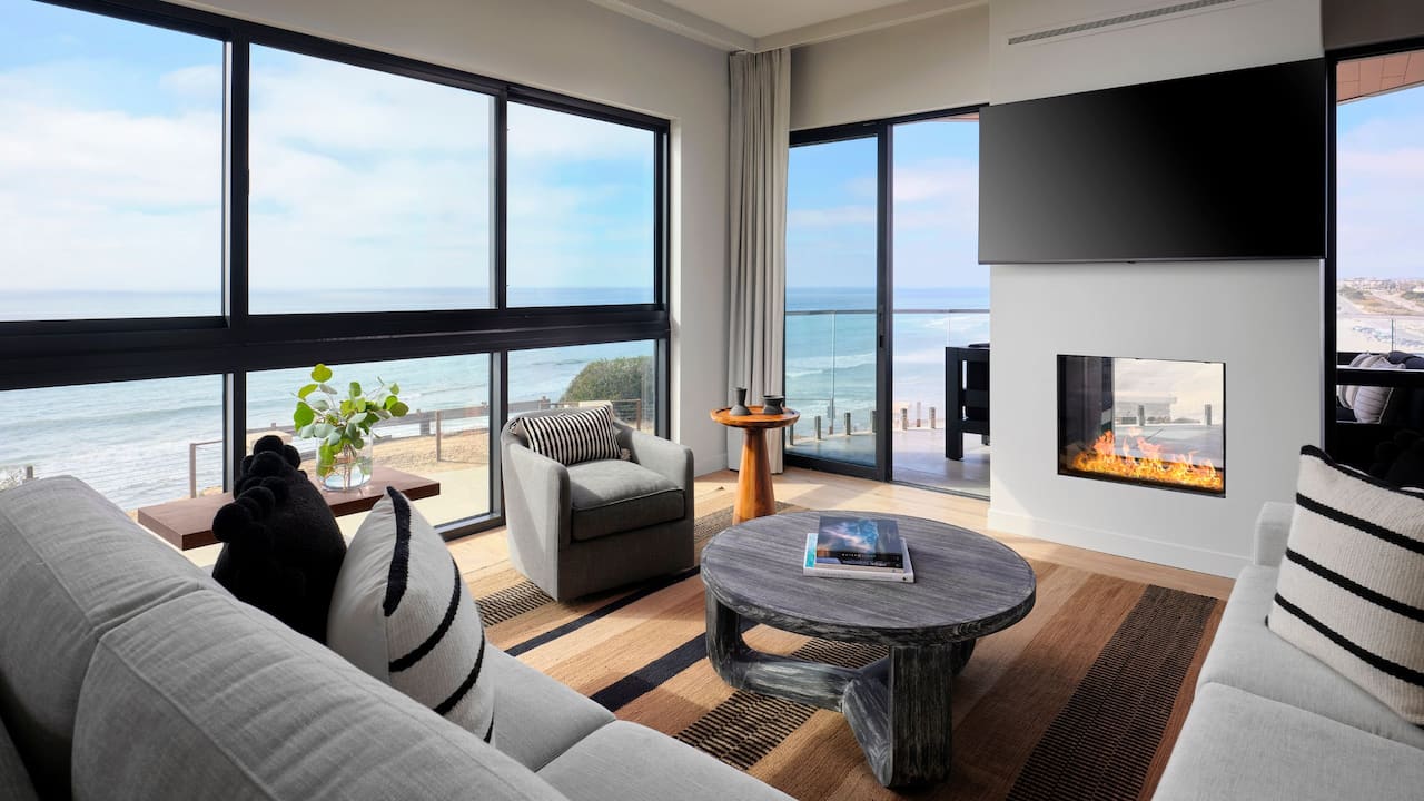 Grandview Suite living area with fireplace and balcony overlooking the ocean