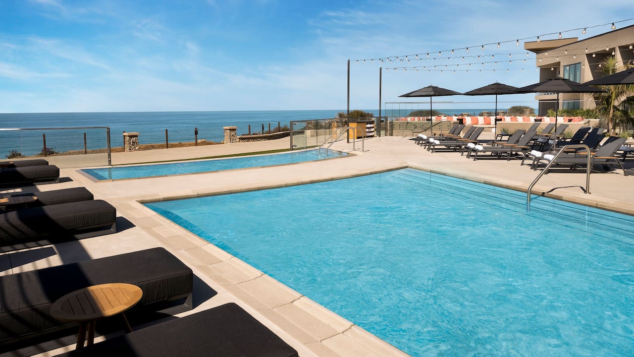 Outdoor pools with ocean views and lounge chairs
