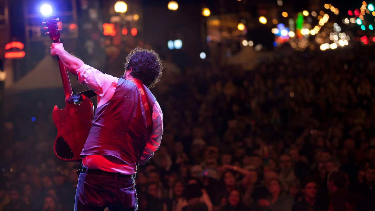 Guitarist performing live at a concert