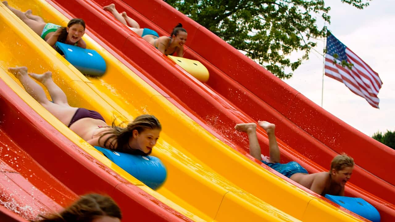 Kids and adults sliding down a water slide at Nashville Shores