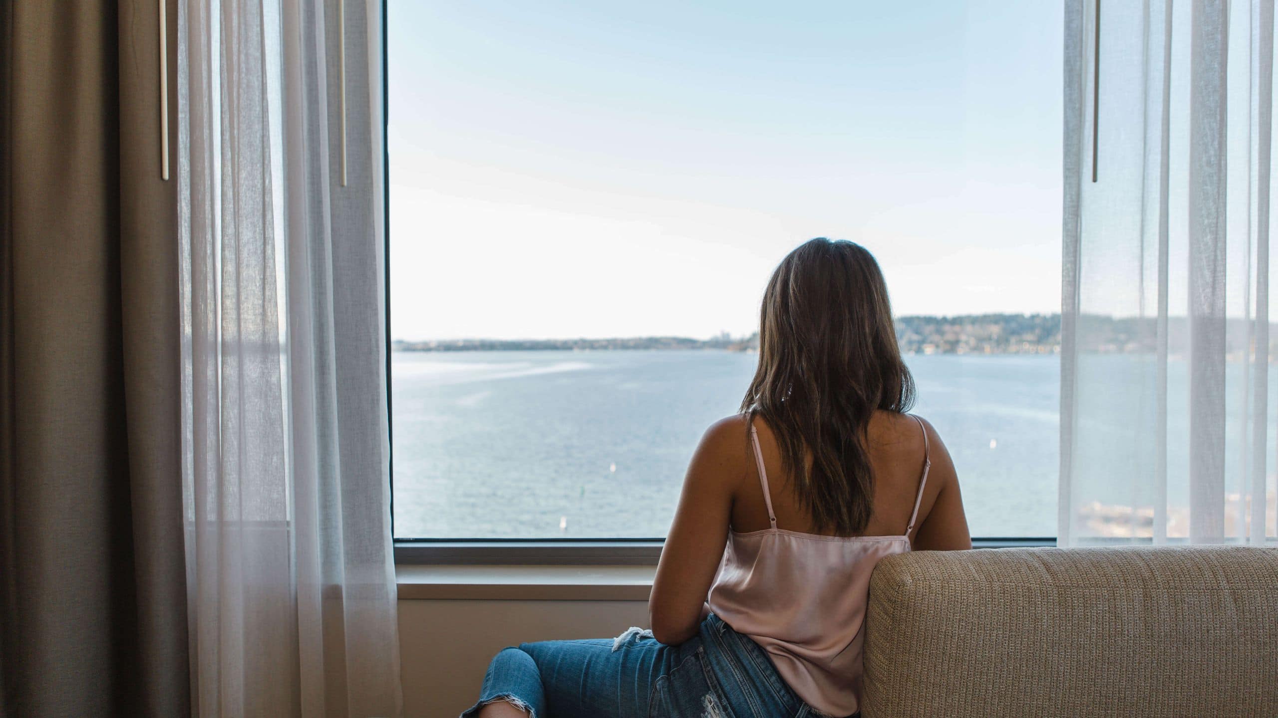 Hyatt Regency Lake Washington at Seattle's Southport Woman Looking Out Window