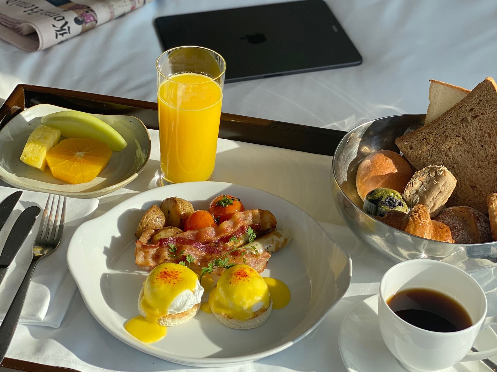 Room service breakfast at Hyatt Regency Stratford London composed of eggs, bacon, pastries and bread on a platter