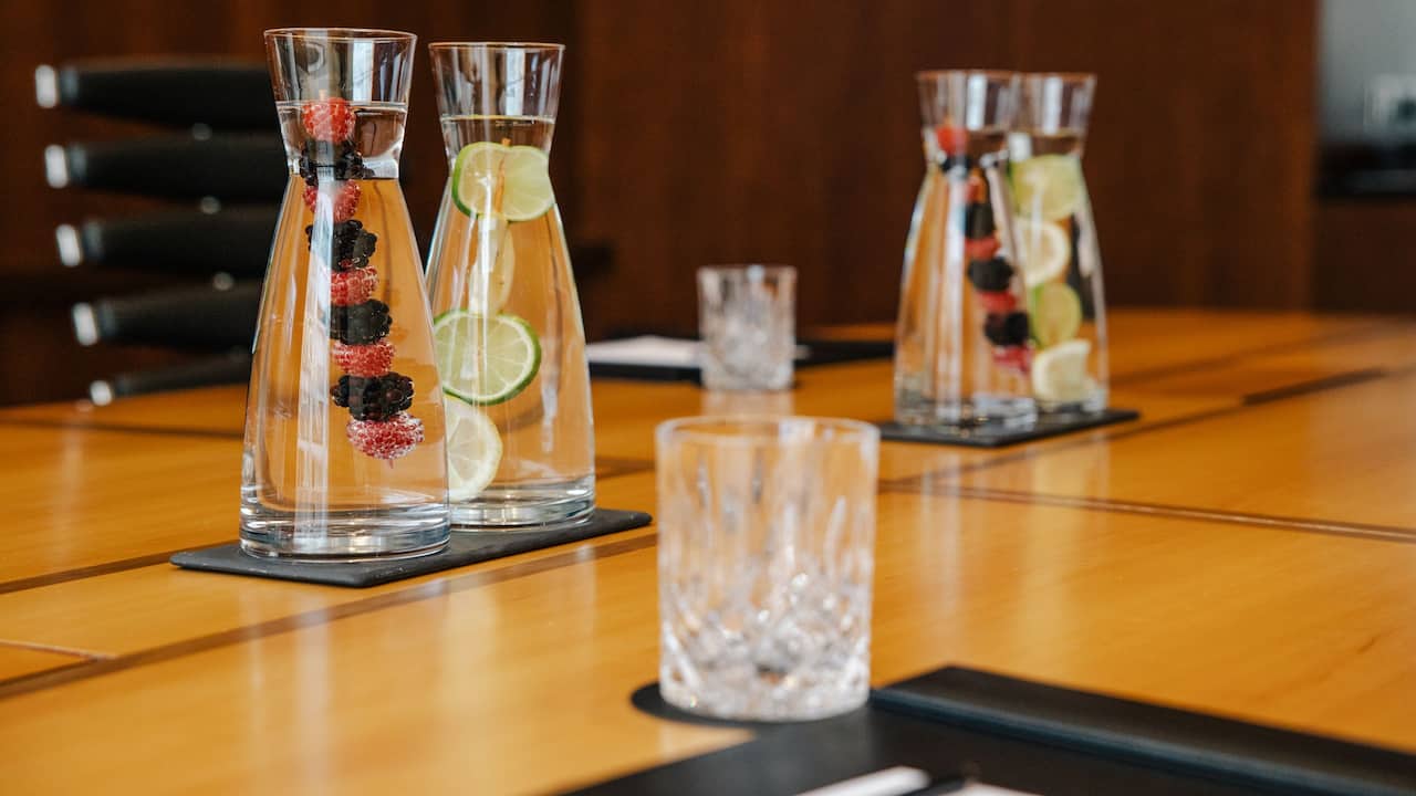 Caraffes with fruit-infused water in an elegant boardroom