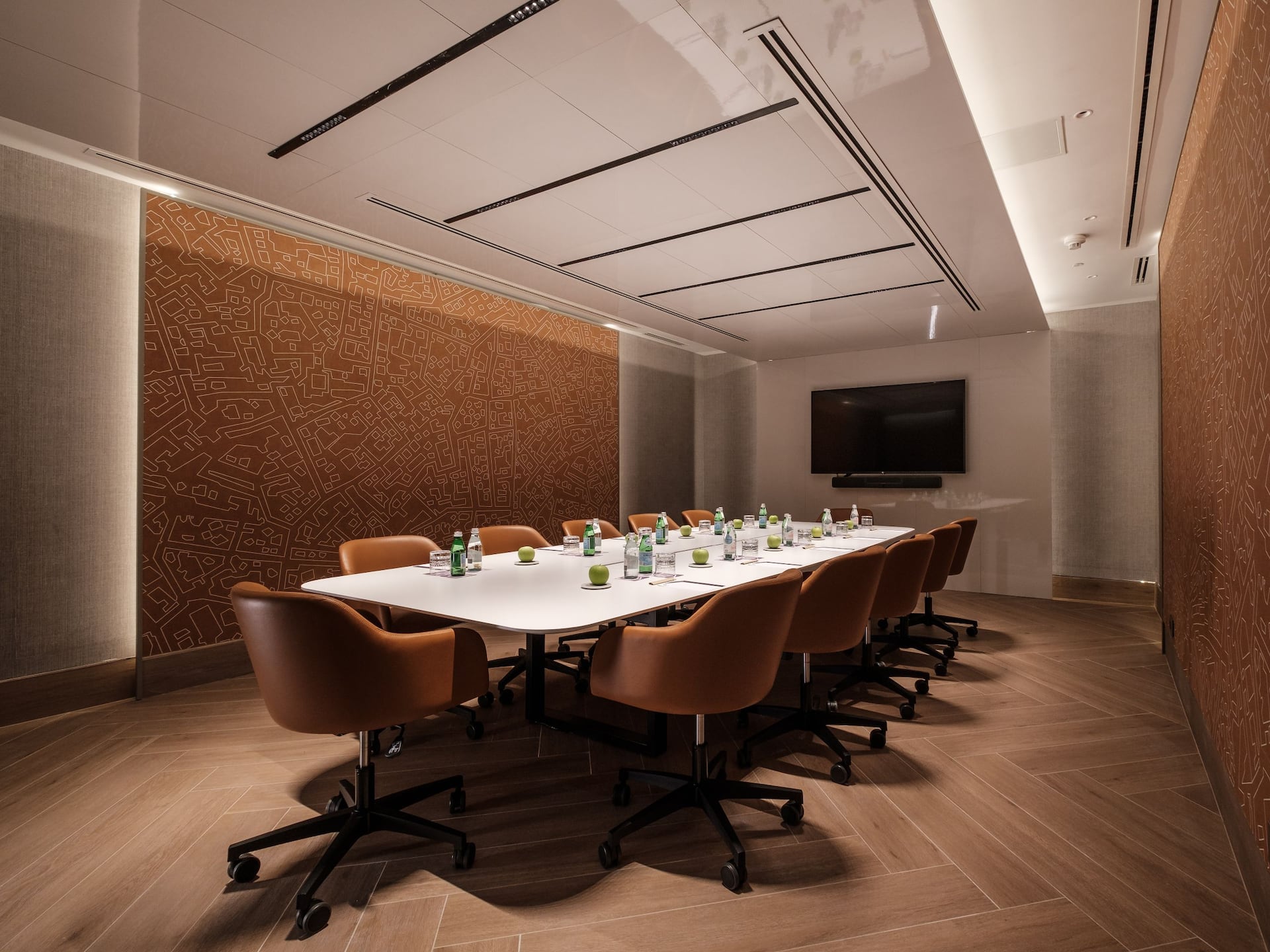 The Executive Boardroom set up for 10 people in boardroom style with notepads, pens, water and an apple
