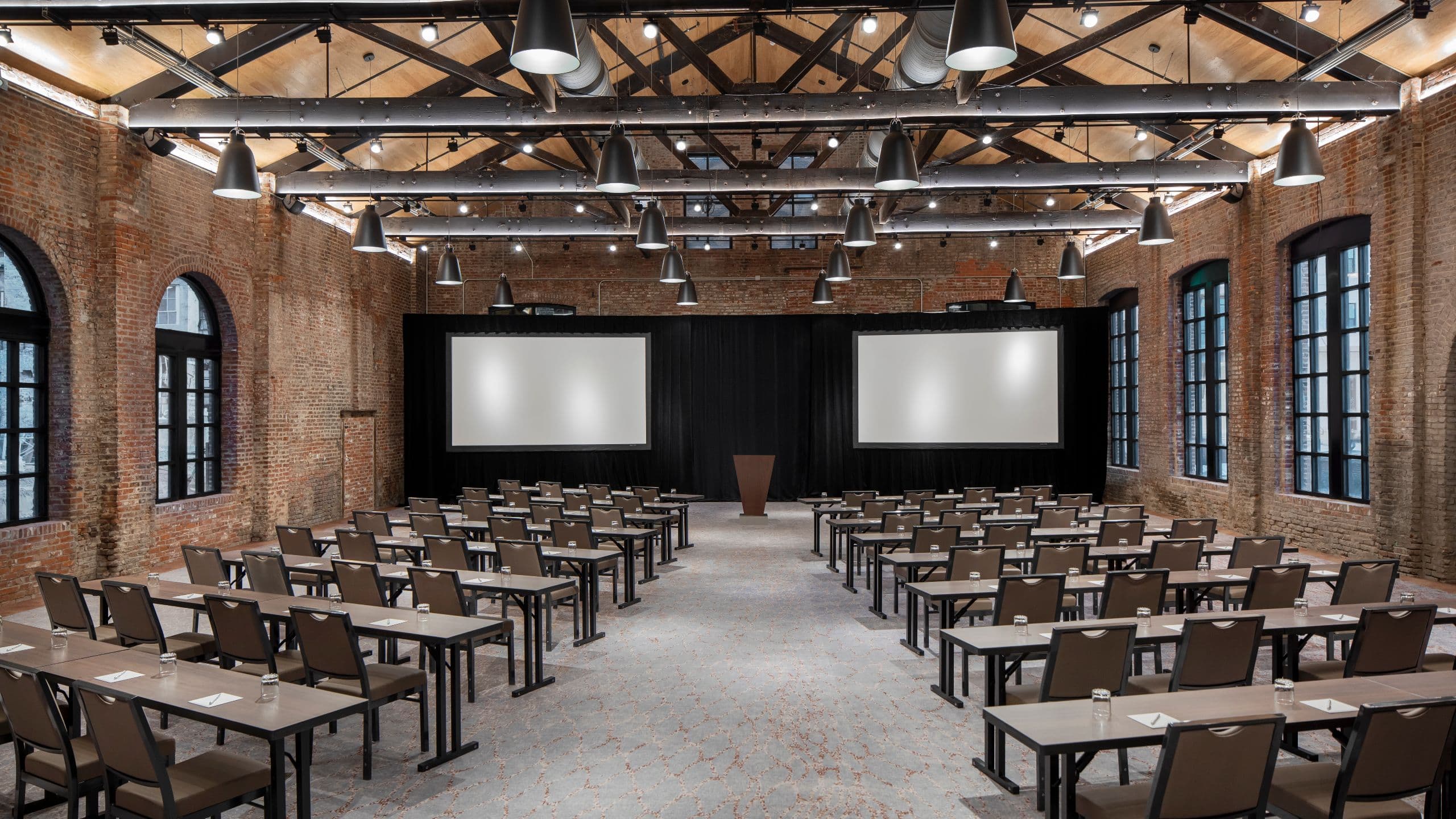 Foundry Ballroom with classroom set-up including podium and projector screens