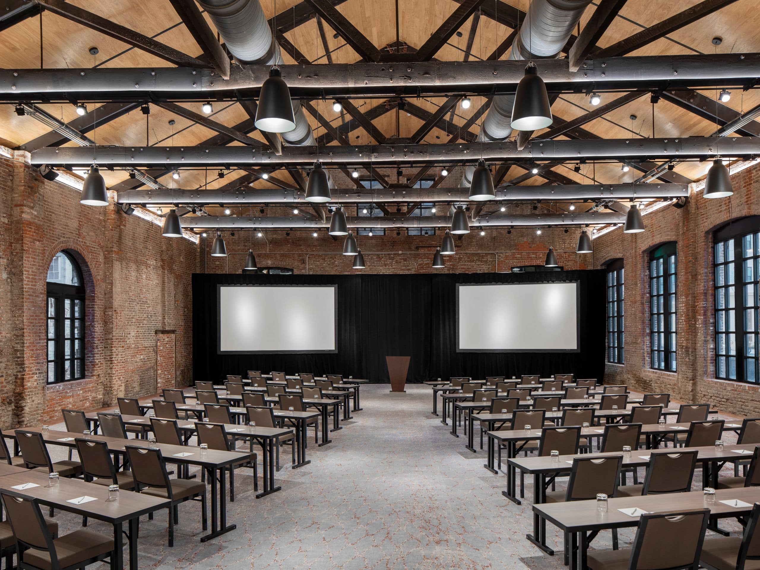 Foundry Ballroom with classroom set-up including podium and projector screens
