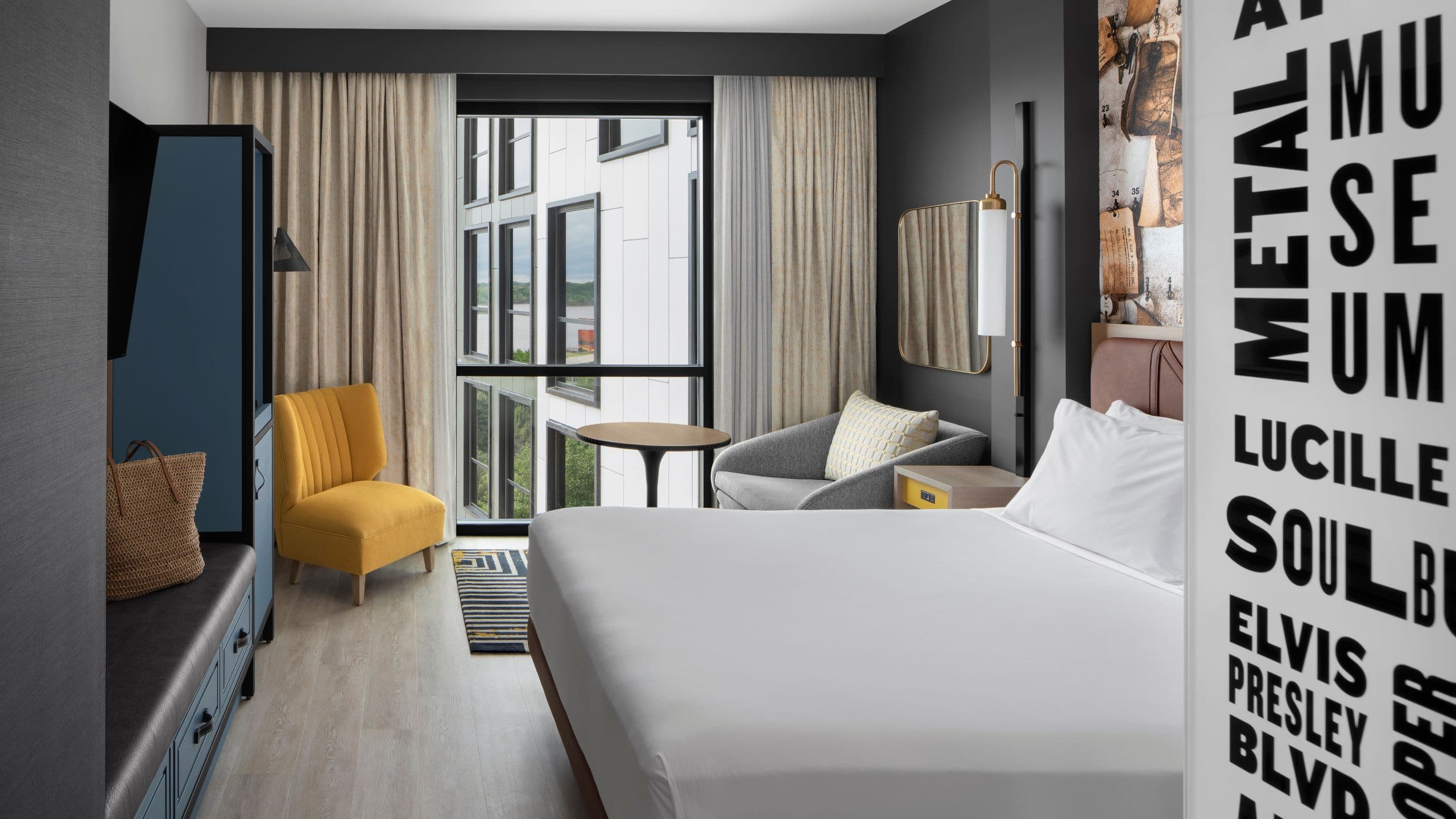 1/4 One King Bed guest room with seating area and floor-to-ceiling window