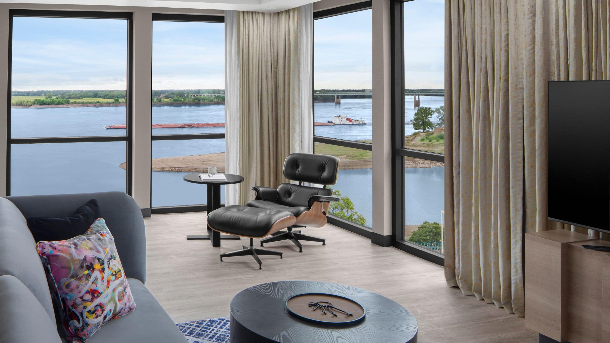 1/4 Premier Suite living room area with floor-to-ceiling views of the Mississippi River