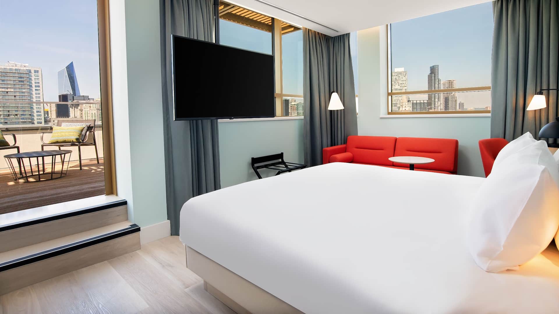 King bedroom at Hyatt Place London City East, with balcony & London city view.