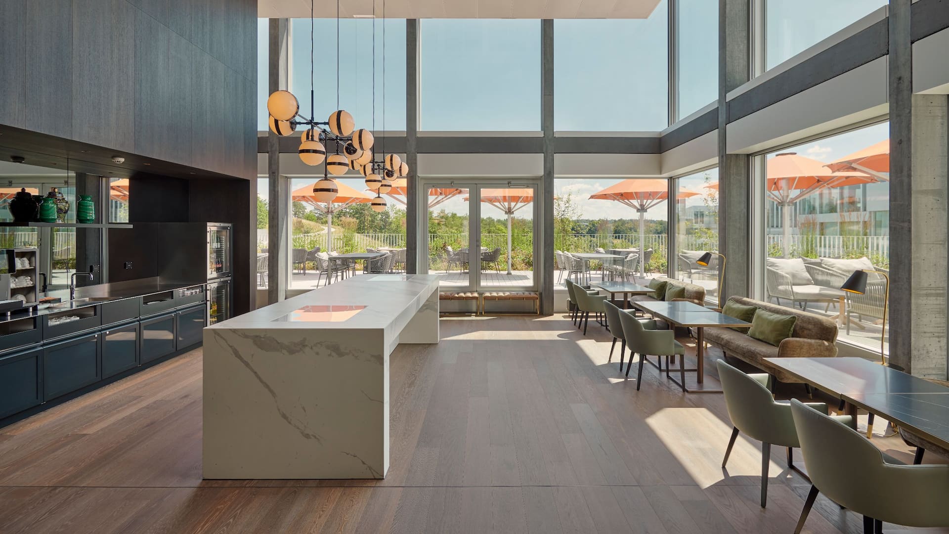 An inviting space in the Regency Club at Hyatt Regency Zurich Airport The Circle, showcasing modern seating arrangements and access to a terrace overlooking the Circle park, offering an exclusive and relaxing atmosphere