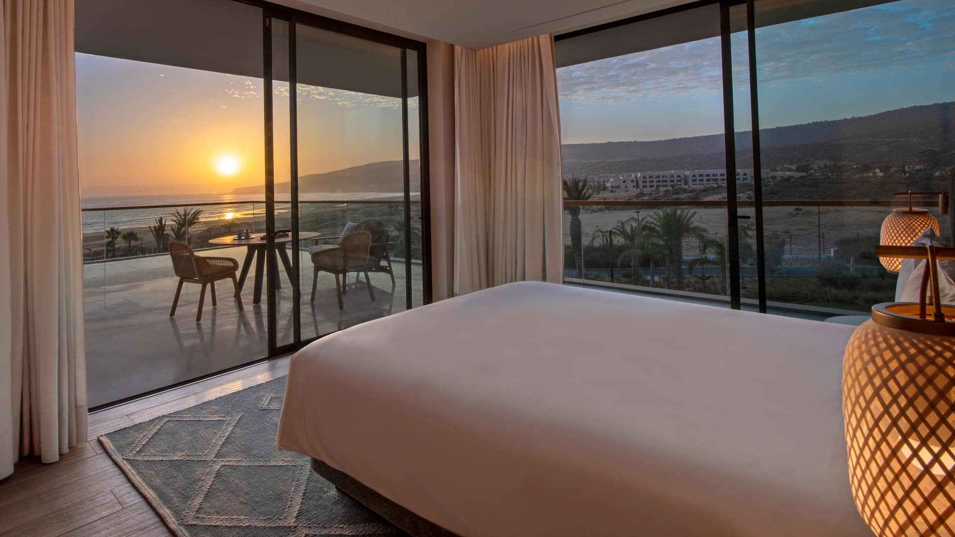 Room with a terrace, offering a sea view, sunset, and a cozy bed