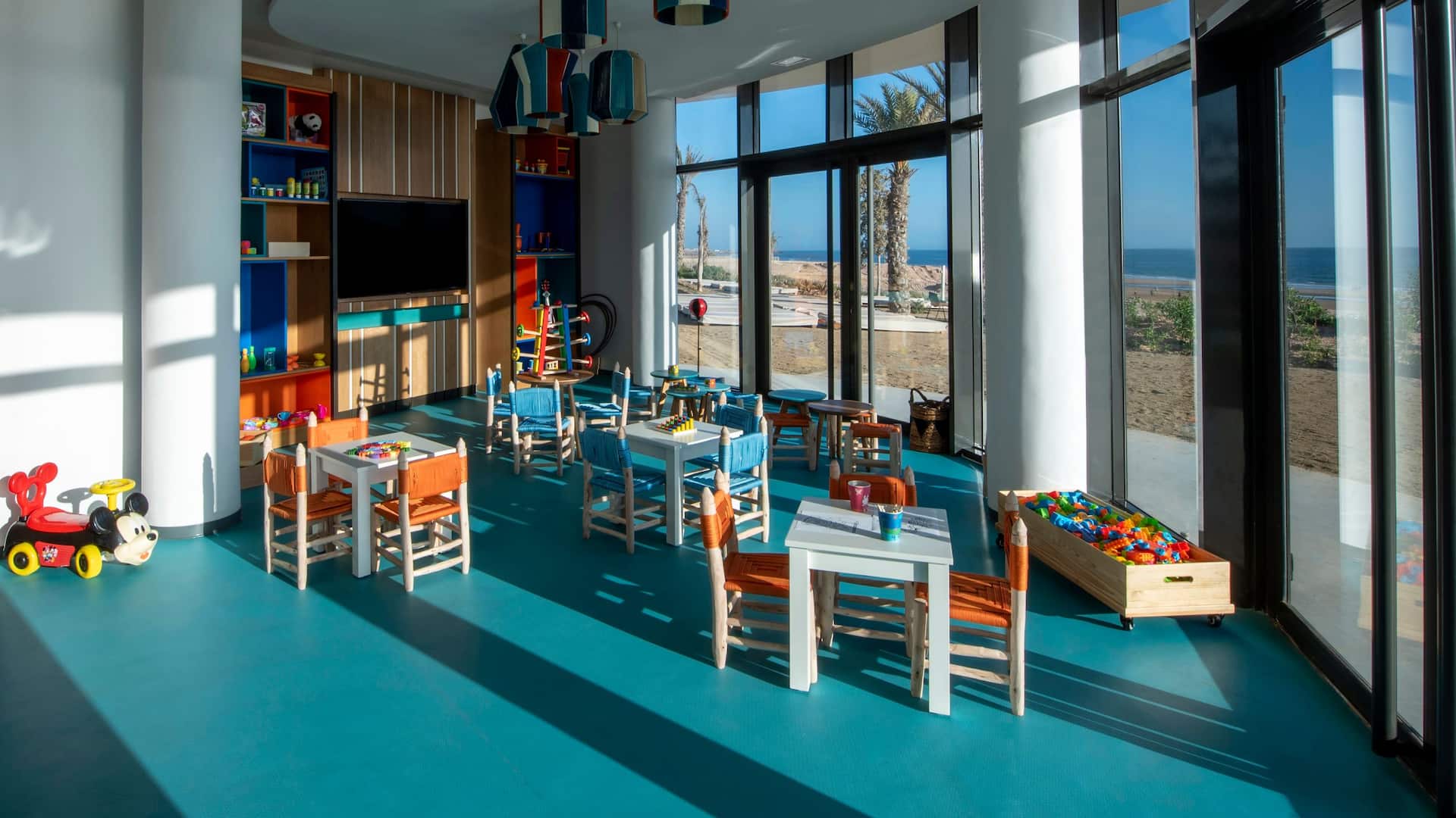 Kids club setup with a corner full of games, offering a fun and colorful space for children to play