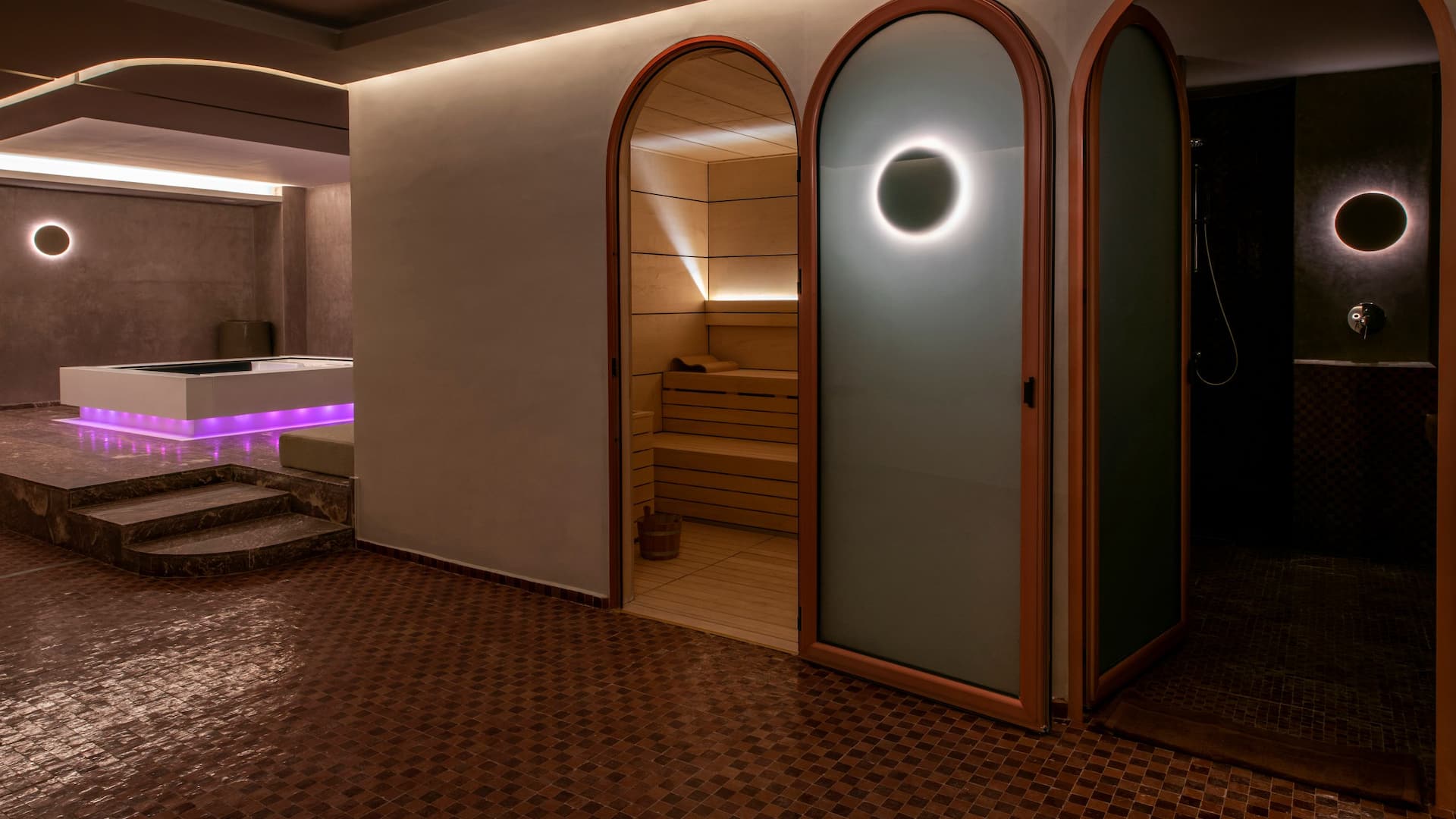 Relaxing spa with a dimly lit atmosphere, featuring a soothing jacuzzi  surrounded by tranquil decor