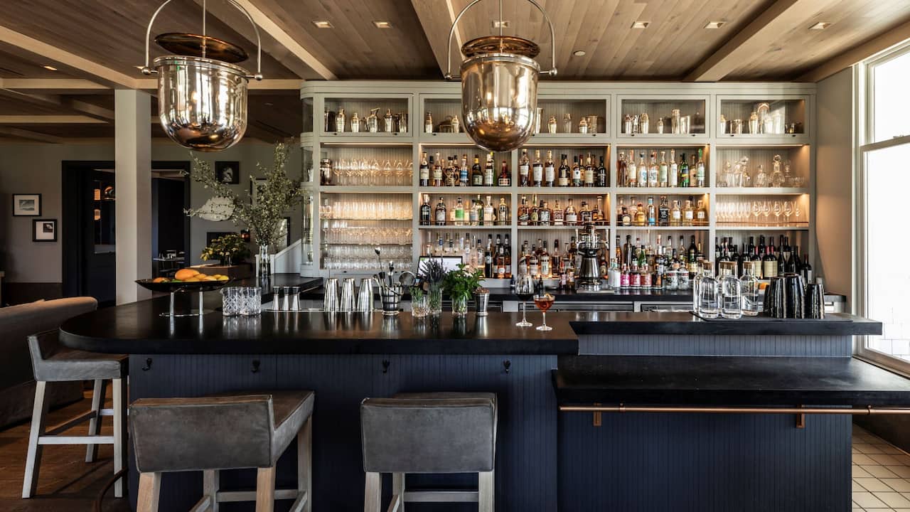 Acacia Bar beverage shelves and bar top seating