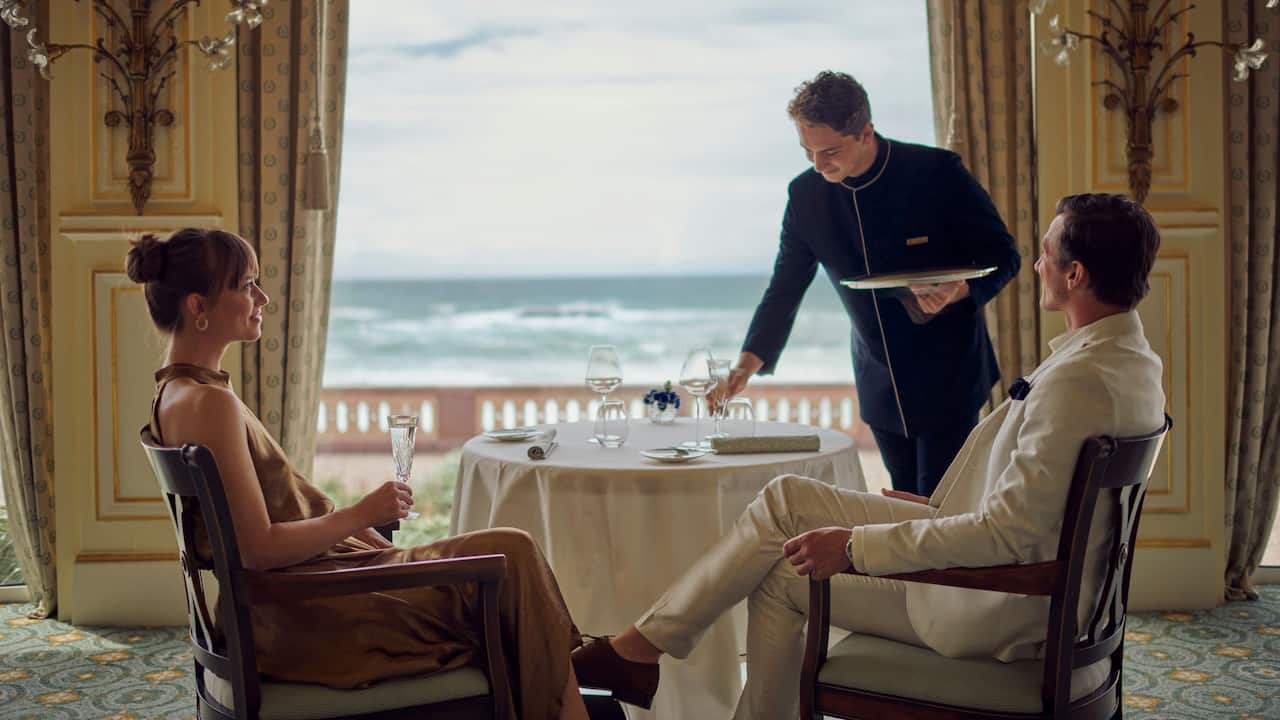 Couple at restaurant in biarritz with sea view Hôtel du Palais part of the Unbound Collection by Hyatt