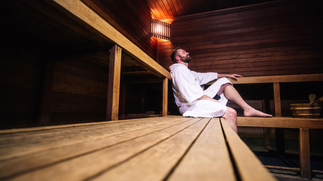 Dry sauna with guest relaxing