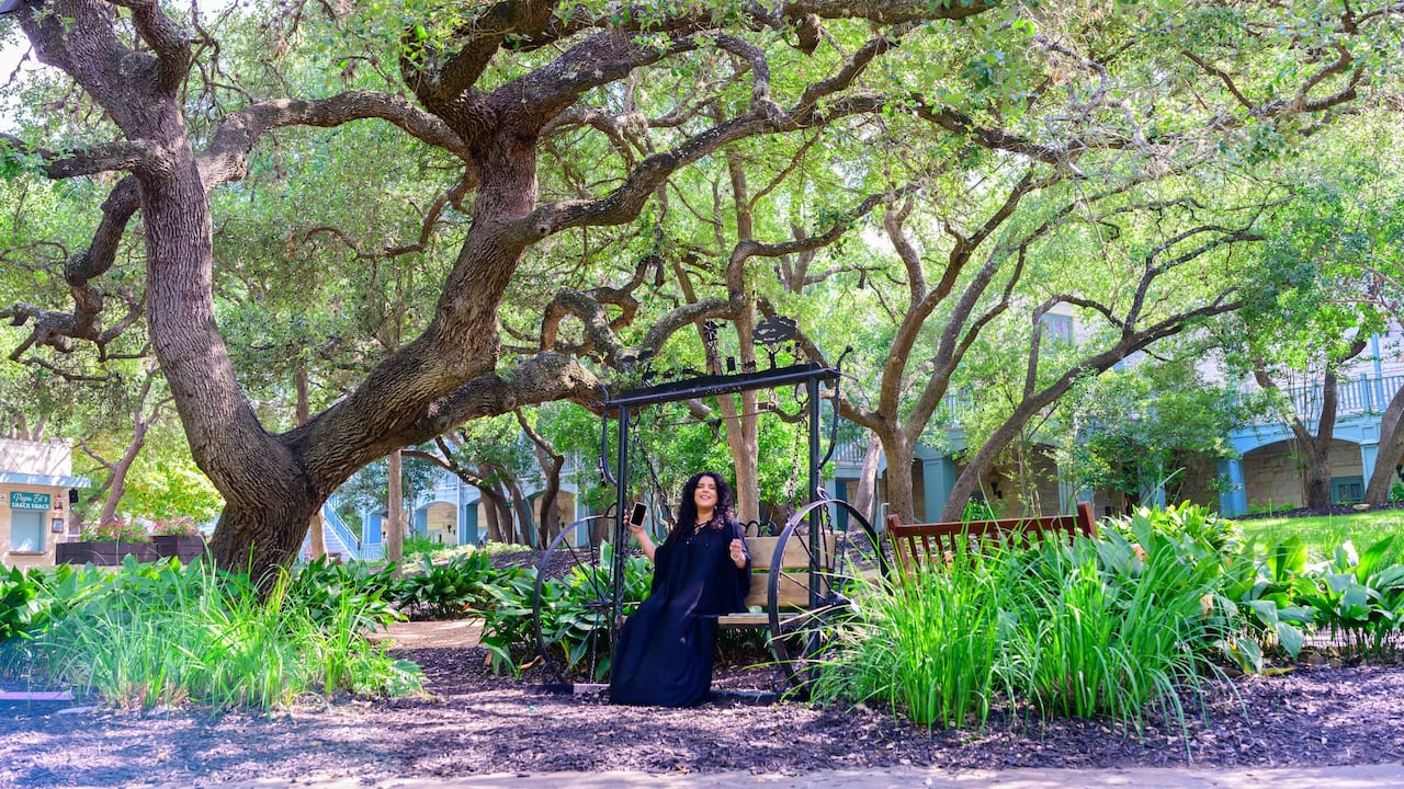 Woman relaxes in swing at San Antonio at Hyatt Regency Hill Country Resort and Spa