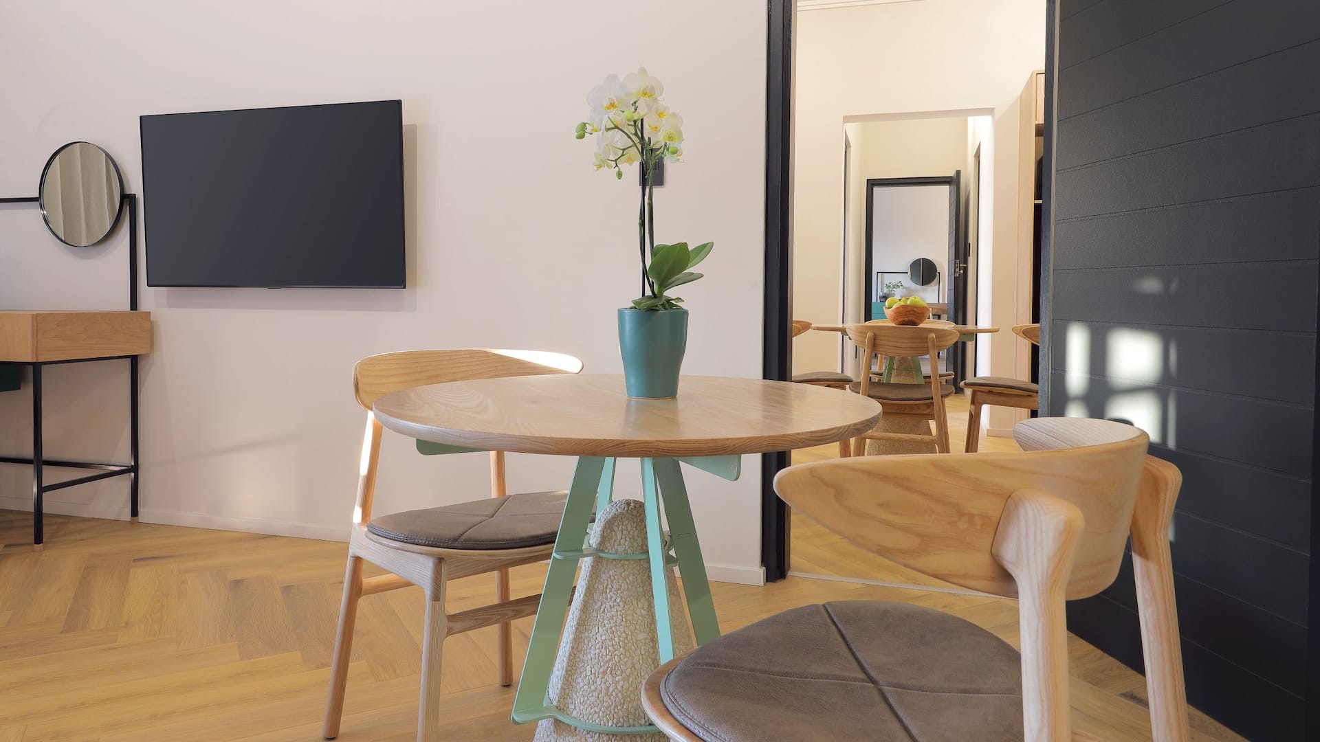 Elegant Two Bedroom Suite with a comfortable living area, separate bedrooms, contemporary furnishings, and warm ambient lighting.