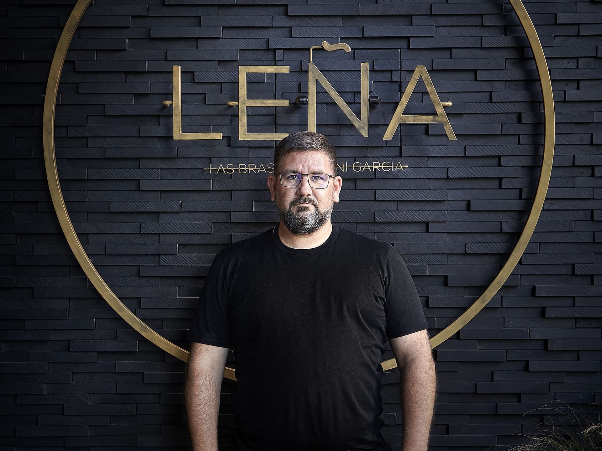 A man standing in front of Lena Restaurant at the Grand Hyatt Barcelona