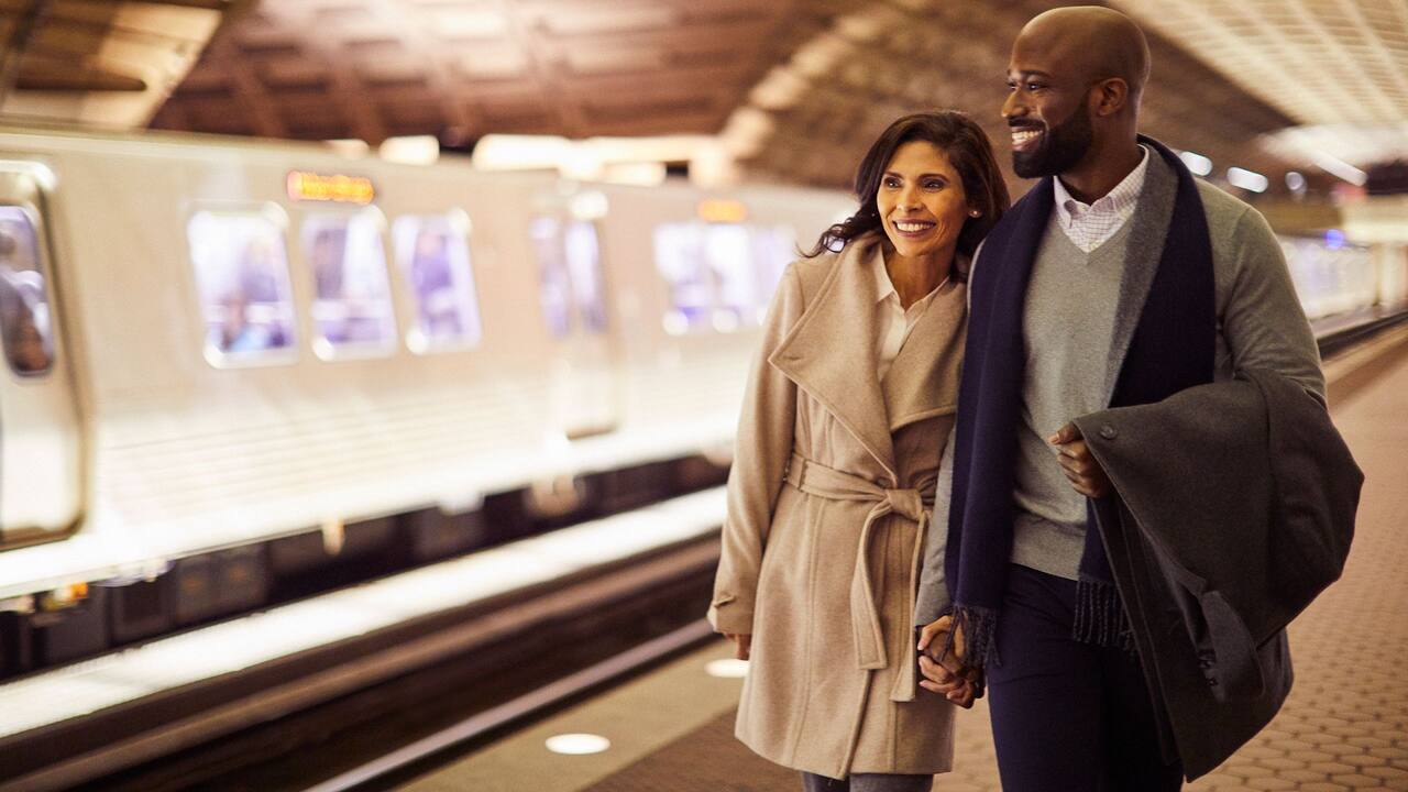 Couple walking hand-in-hand at Metro Station 