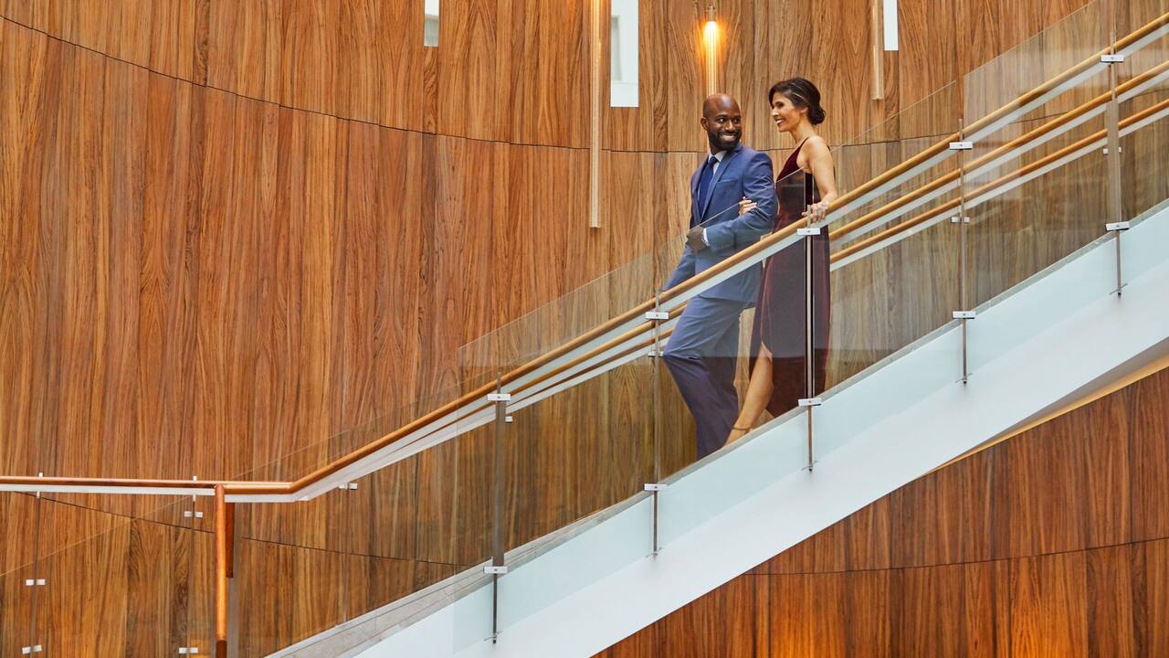 Couple walking down the lobby stairs 