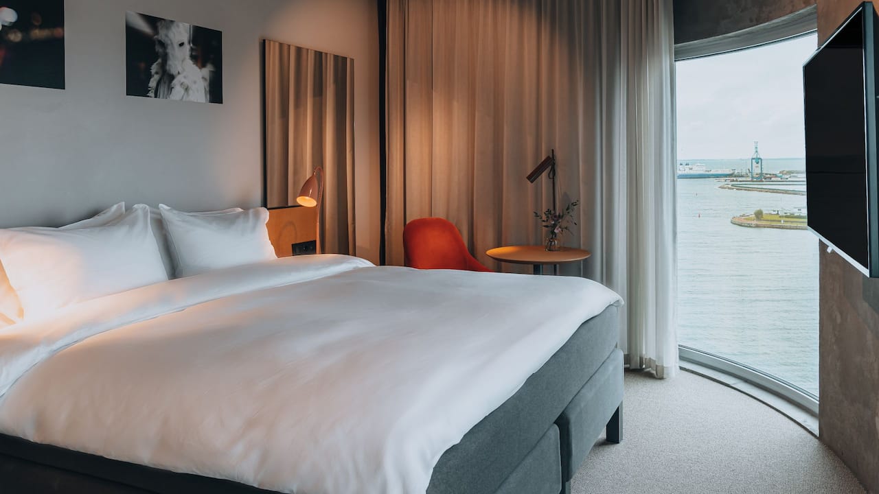Bed, ocean view, table and lights in King Bed Ocean View Deluxe Room