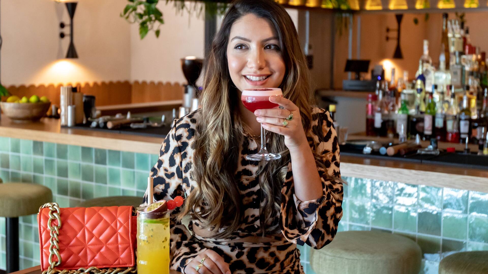Woman holding a cocktail at Dutch bar