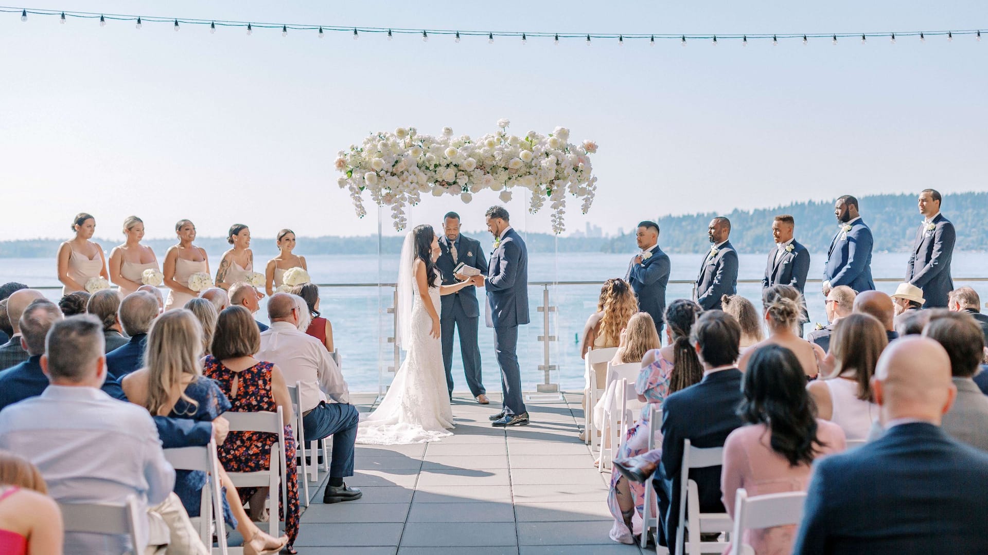 Lake Washington resort wedding ceremony setup with arch overlooking the water