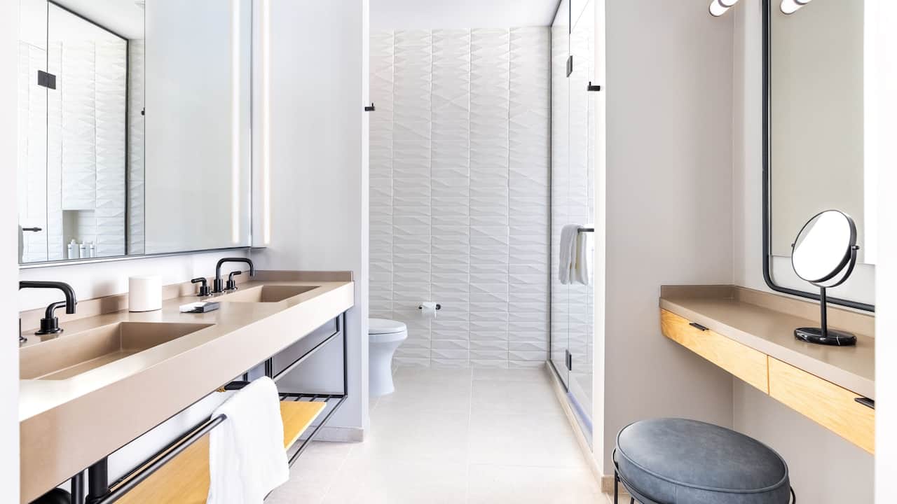King Suite bathroom with double vanities and walk-in shower