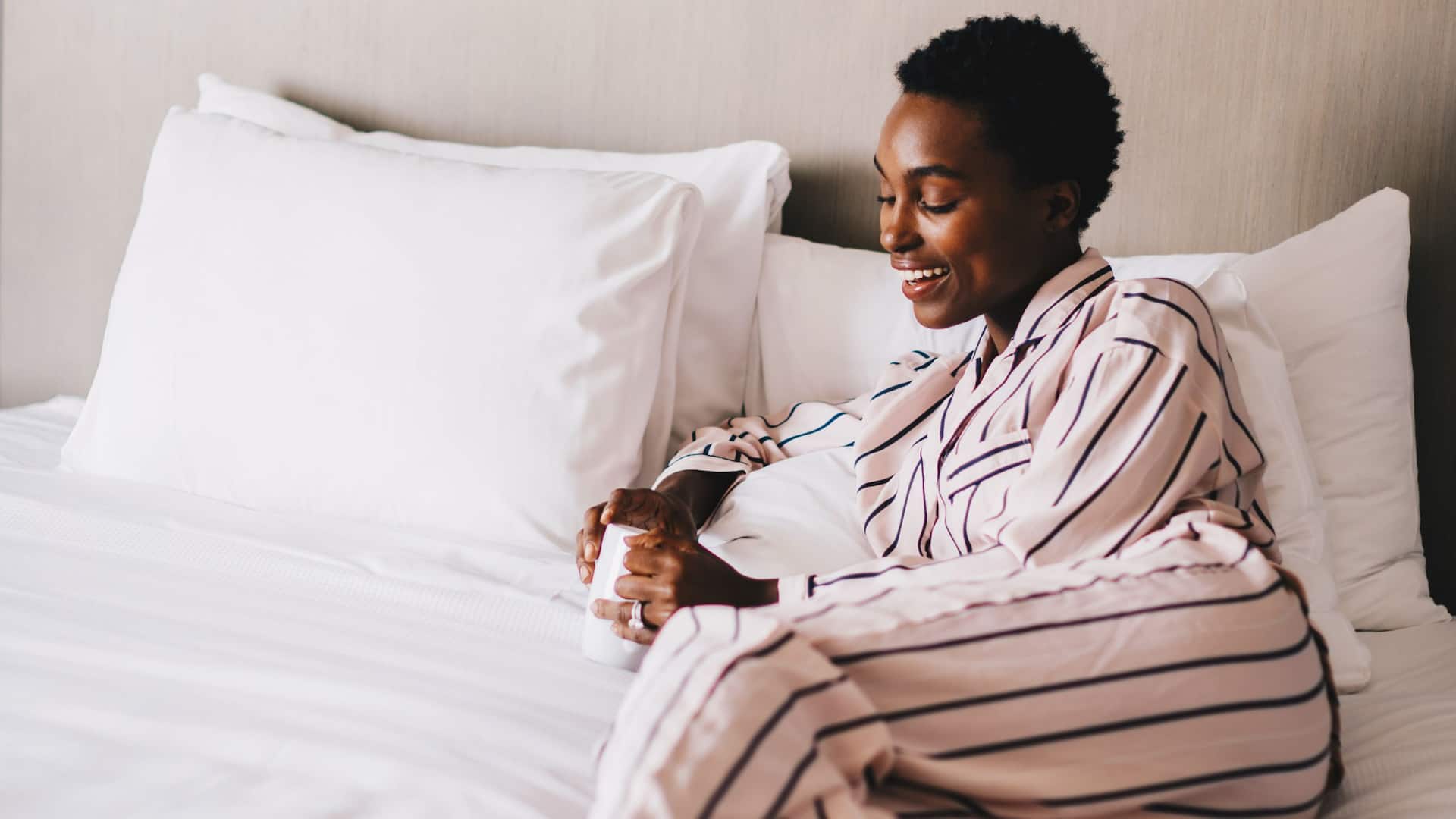 Hyatt House HH_P0605 Woman Drinking Coffee In Bed