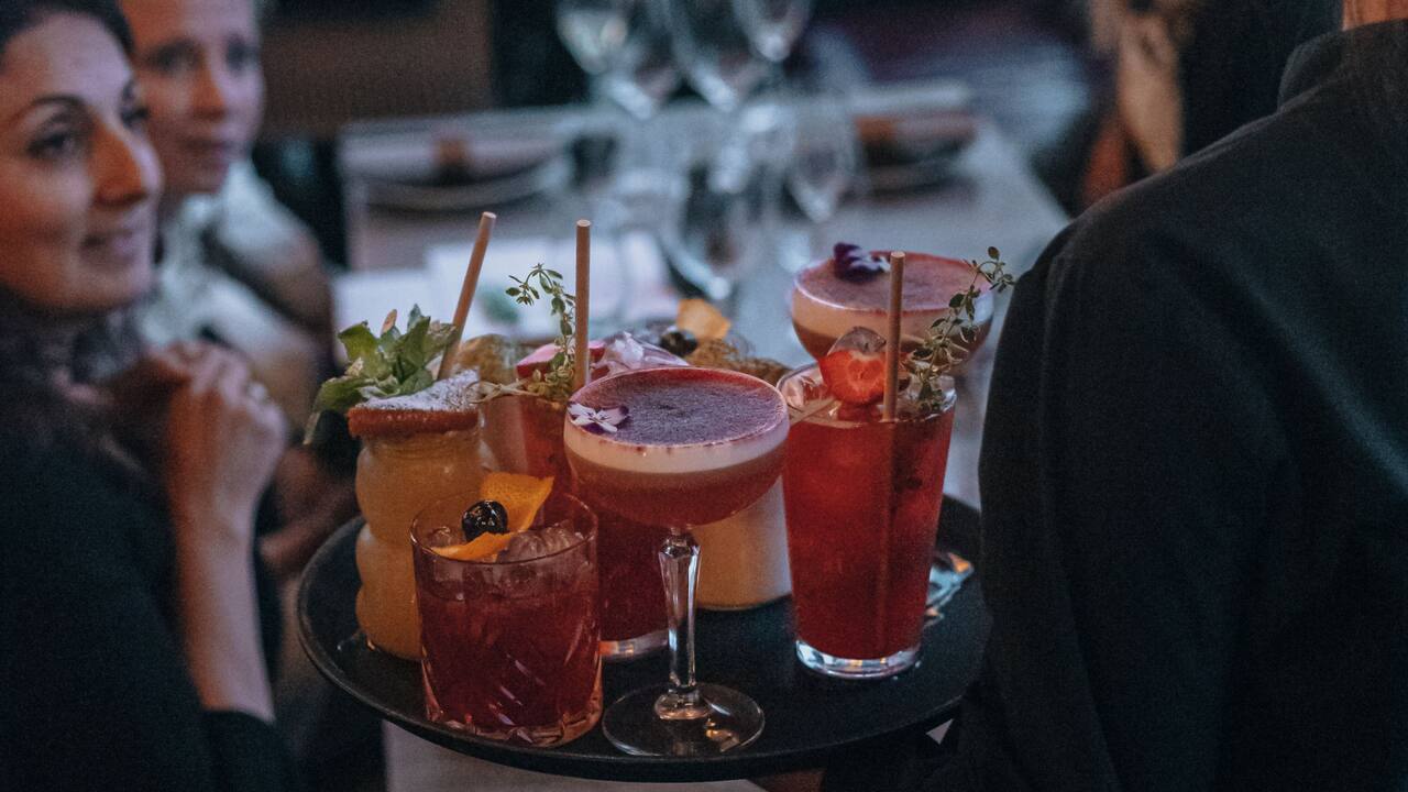 Guests being served colorful drinks 