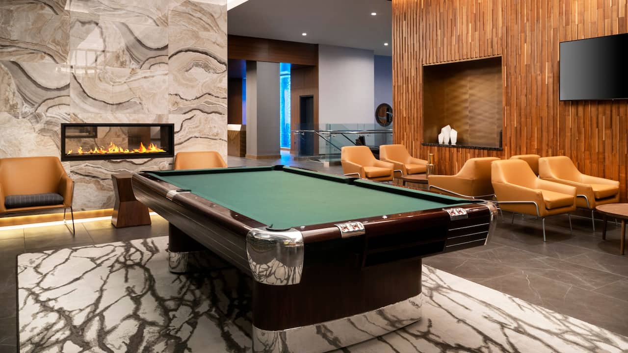 Lobby with pool table and modern fireplace 