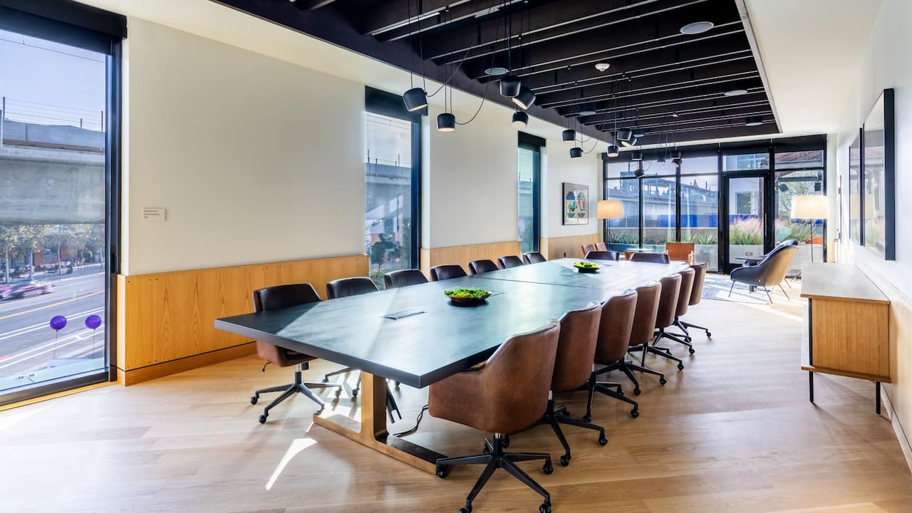 Blackwelder Boardroom with wooden conference table, chairs and floor-to-ceiling windows