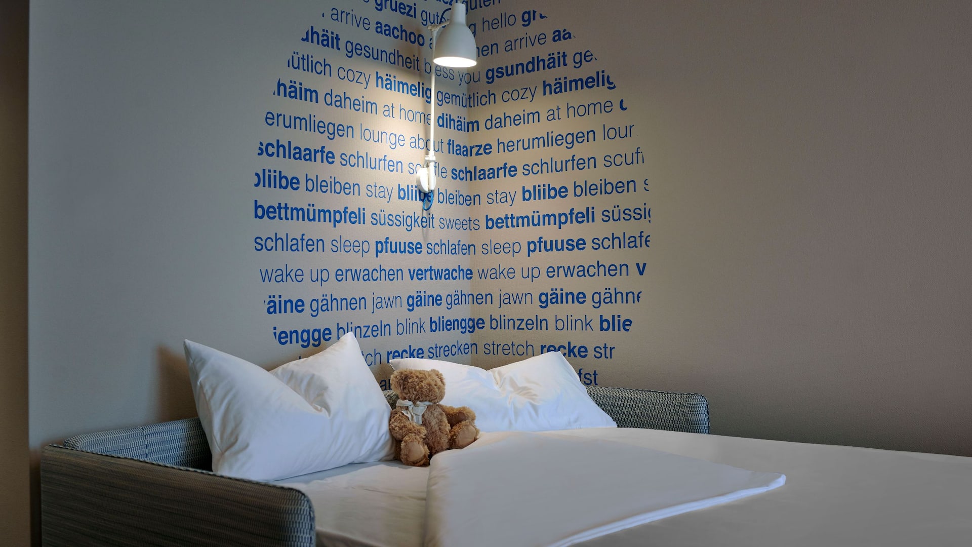 Elegant, modern hotel room in Zurich featuring 2 twin beds and a comfortable sofa bed, perfect for families with children.