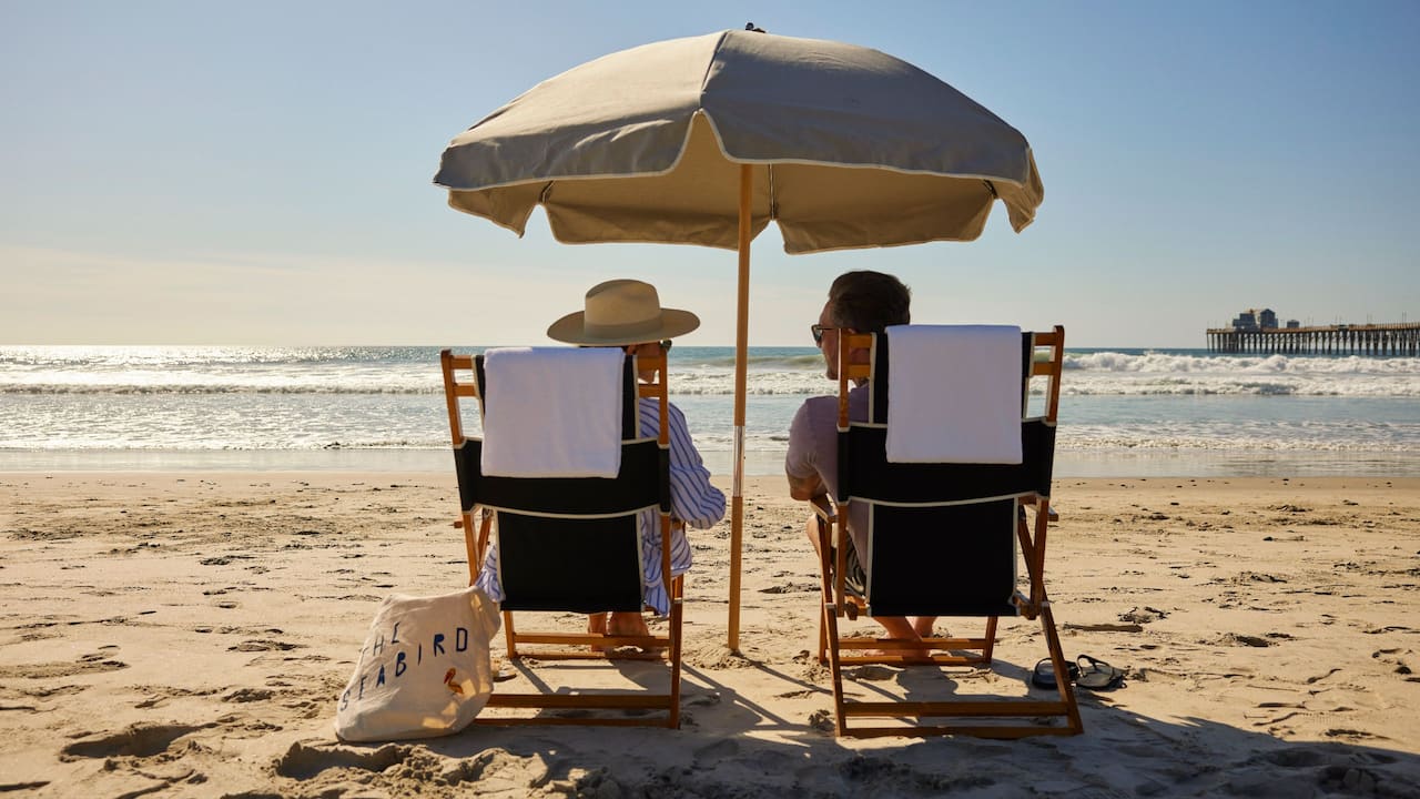 Beach Pier Chairs Umbrella Couple