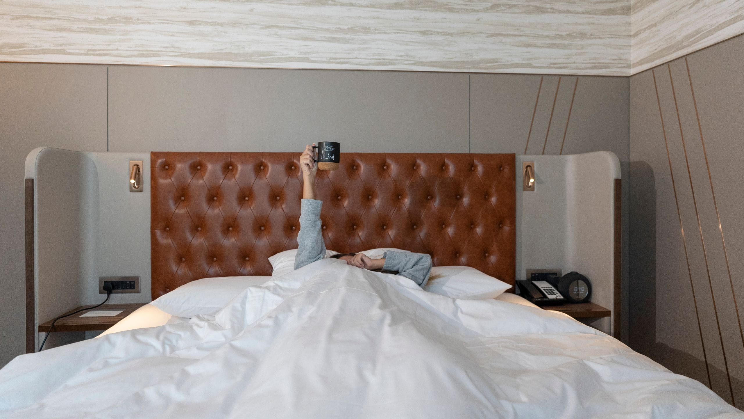 Hyatt Centric Jumeirah Dubai Guest Holding Mug In Bed