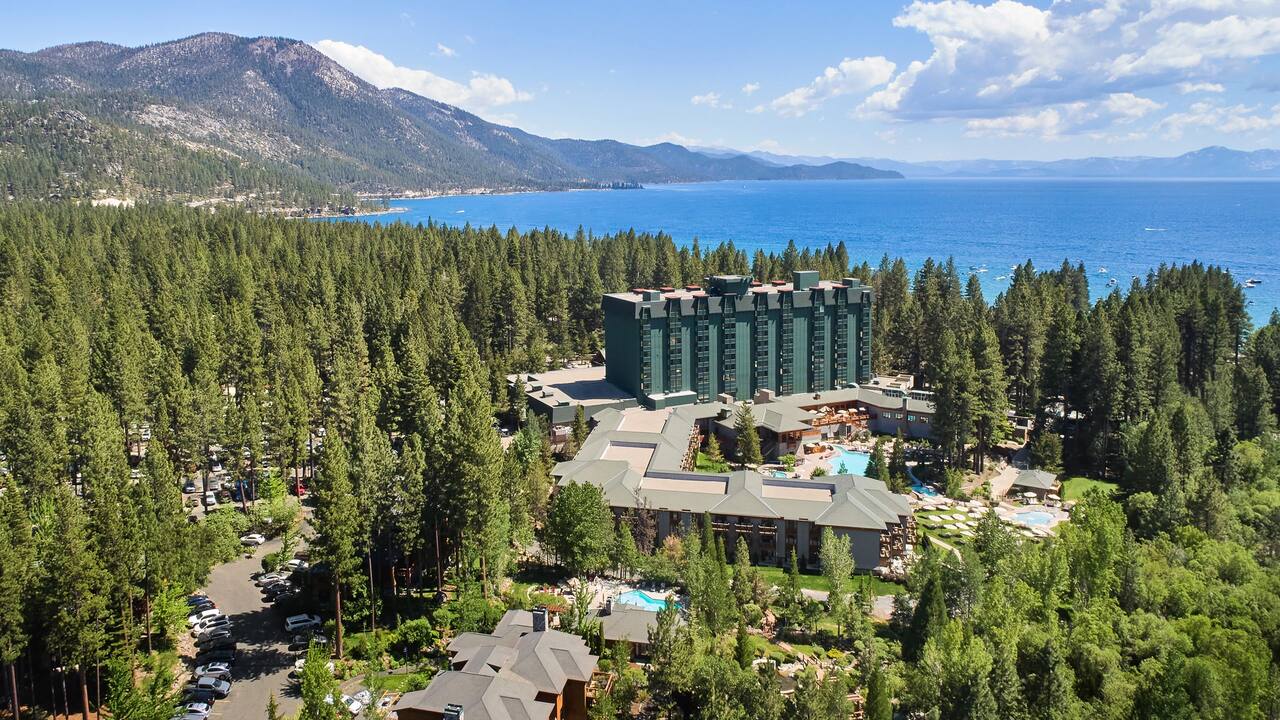 Hyatt Regency Lake Tahoe aerial view of the property, forrest, mountains and Lake Tahoe on the horizon