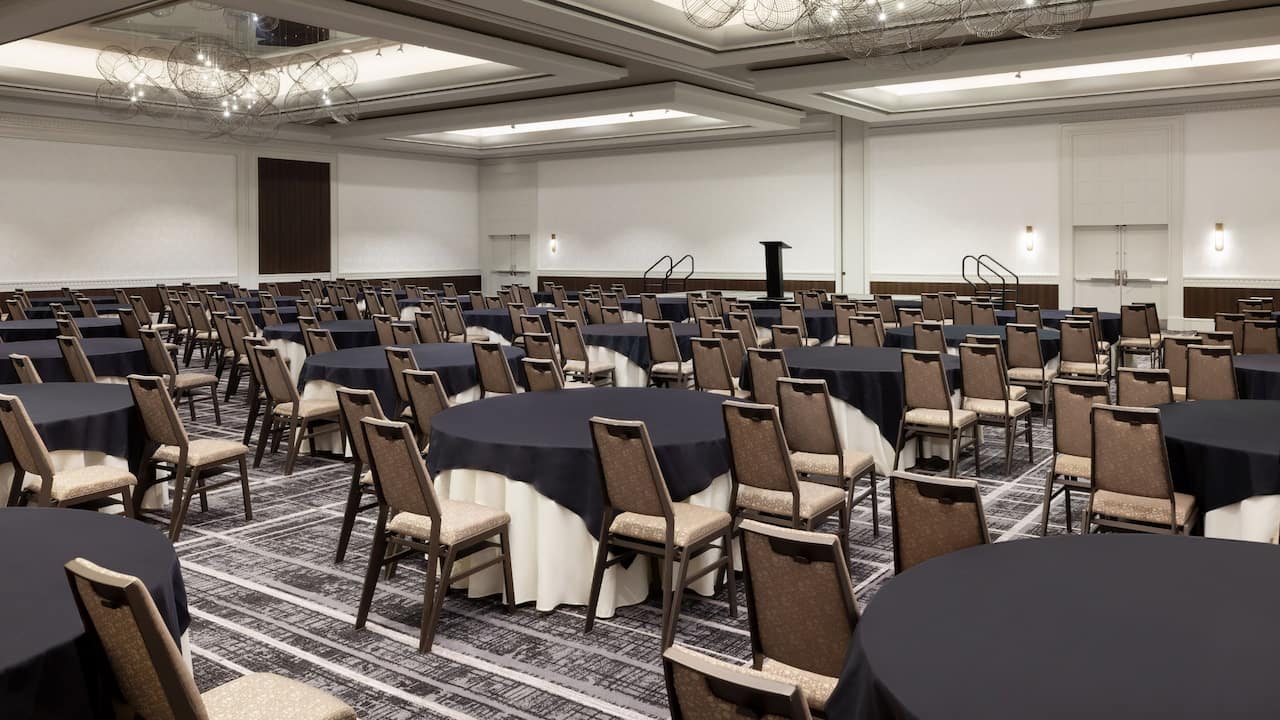 Gallery Ballroom with round tables and podium