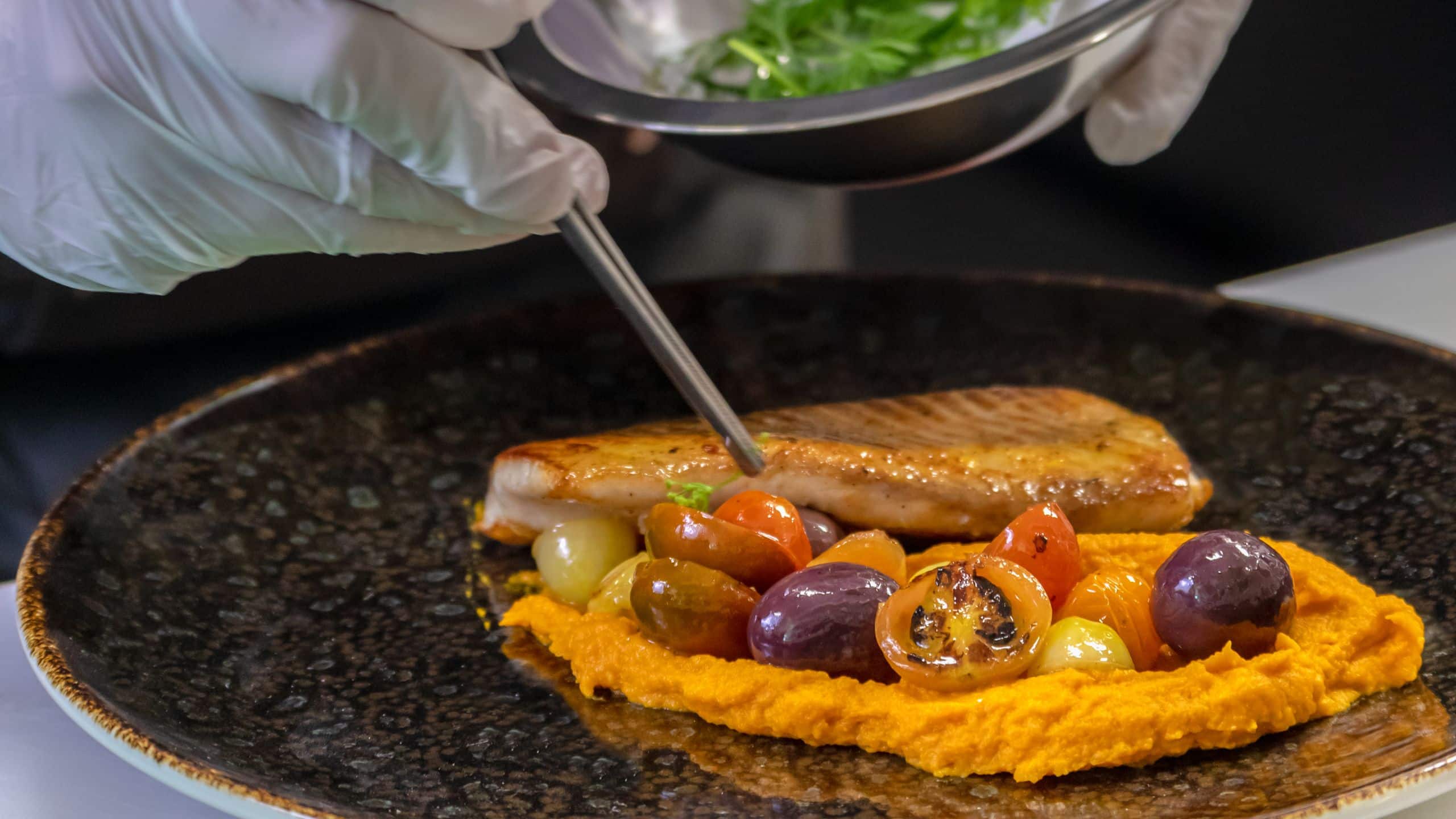 4 of 5 Hyatt Centric San Salvador Chef Plating Seafood Tomatoes