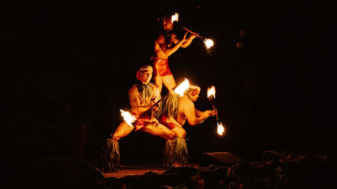 Trio of fire knife dancers at Drums of the Pacific Luau