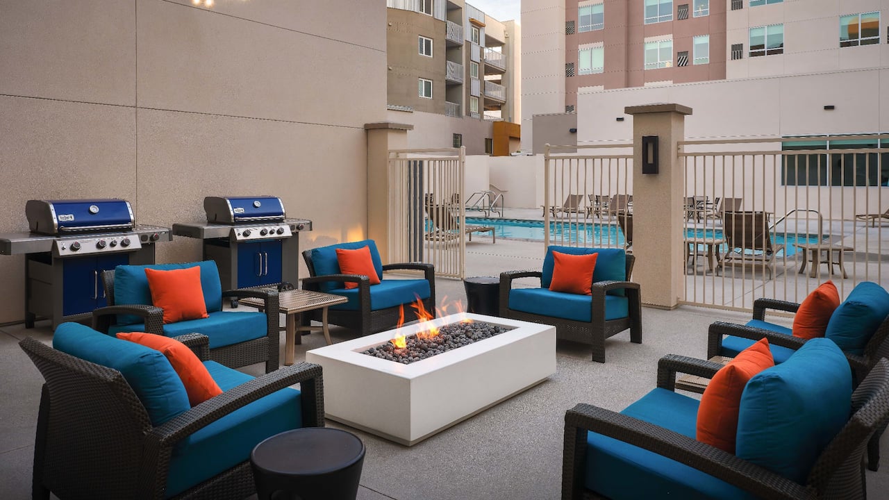 Patio area with lounge seating, firepit and gas grills 