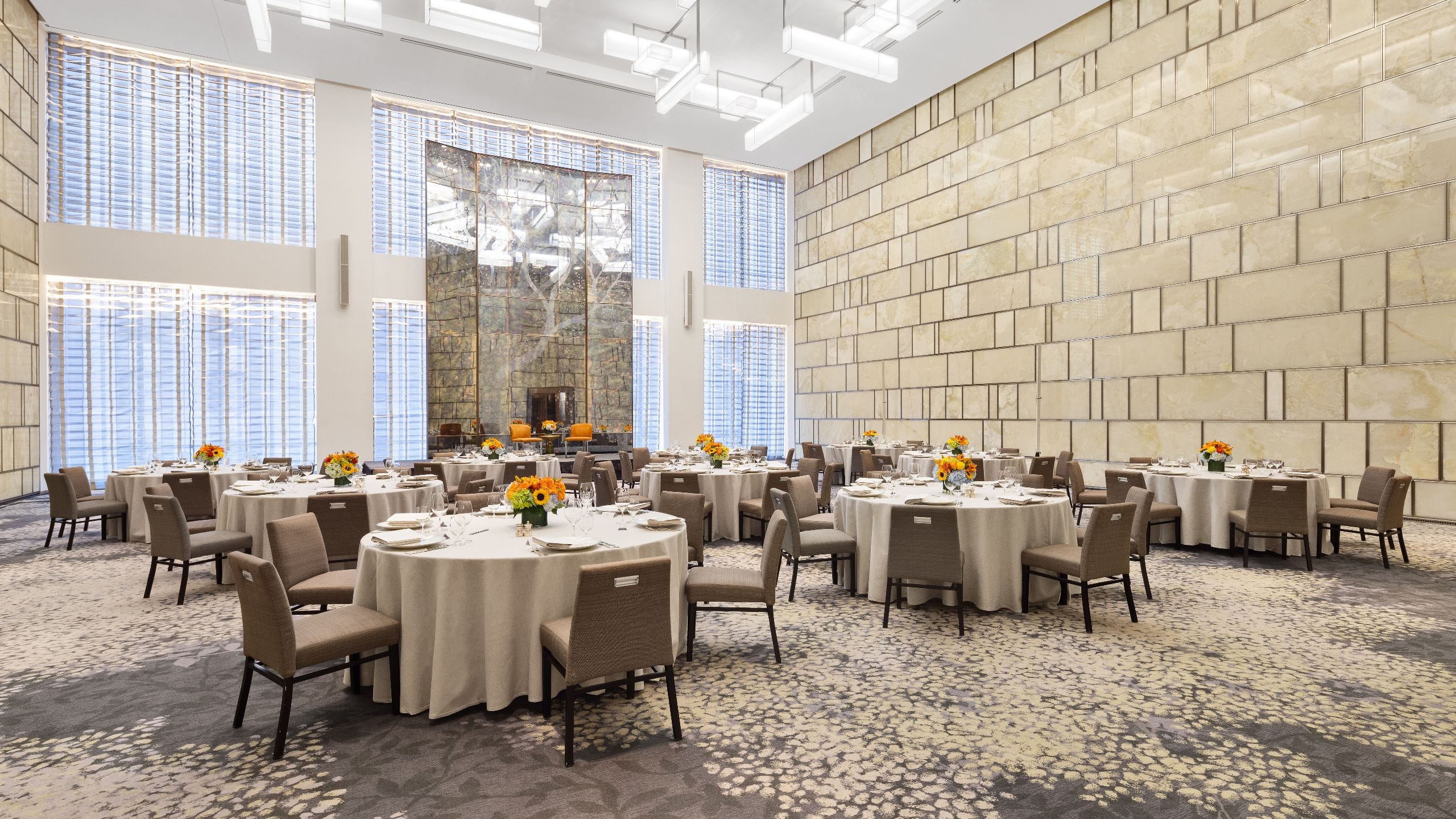1 of 1 Ballroom with elegant chandeliers and round tables set up for a luxurious event
