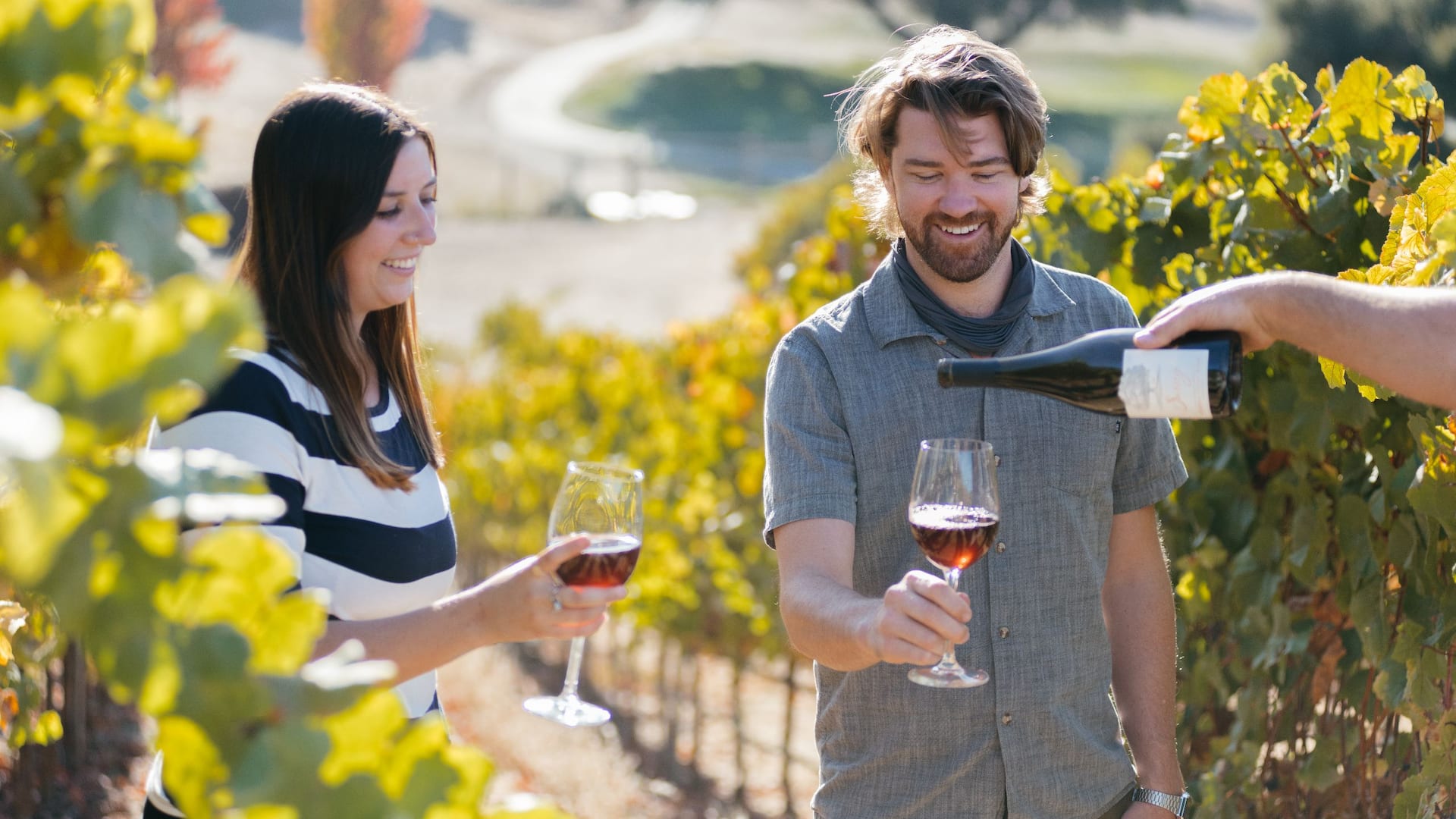 Couple enjoys wine tasting in the vineyards