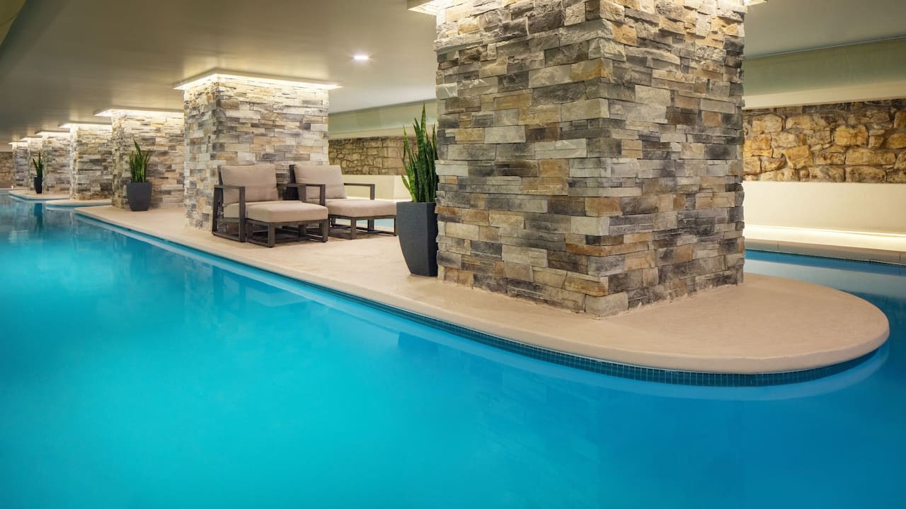 Indoor lap pool with poolside lounge chairs