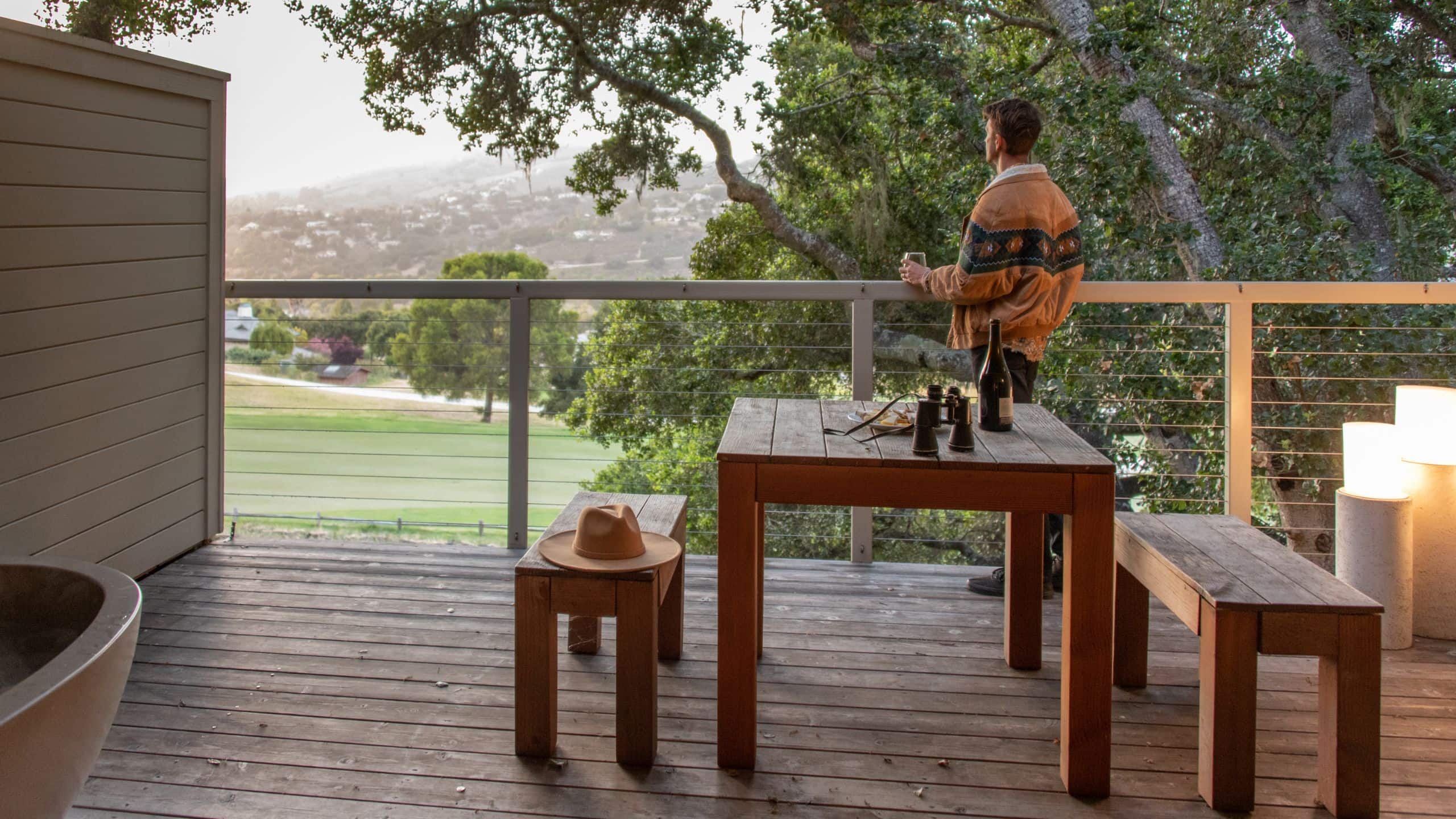 3/4 Carmel Valley Ranch Guestroom Balcony Man Standing Wine