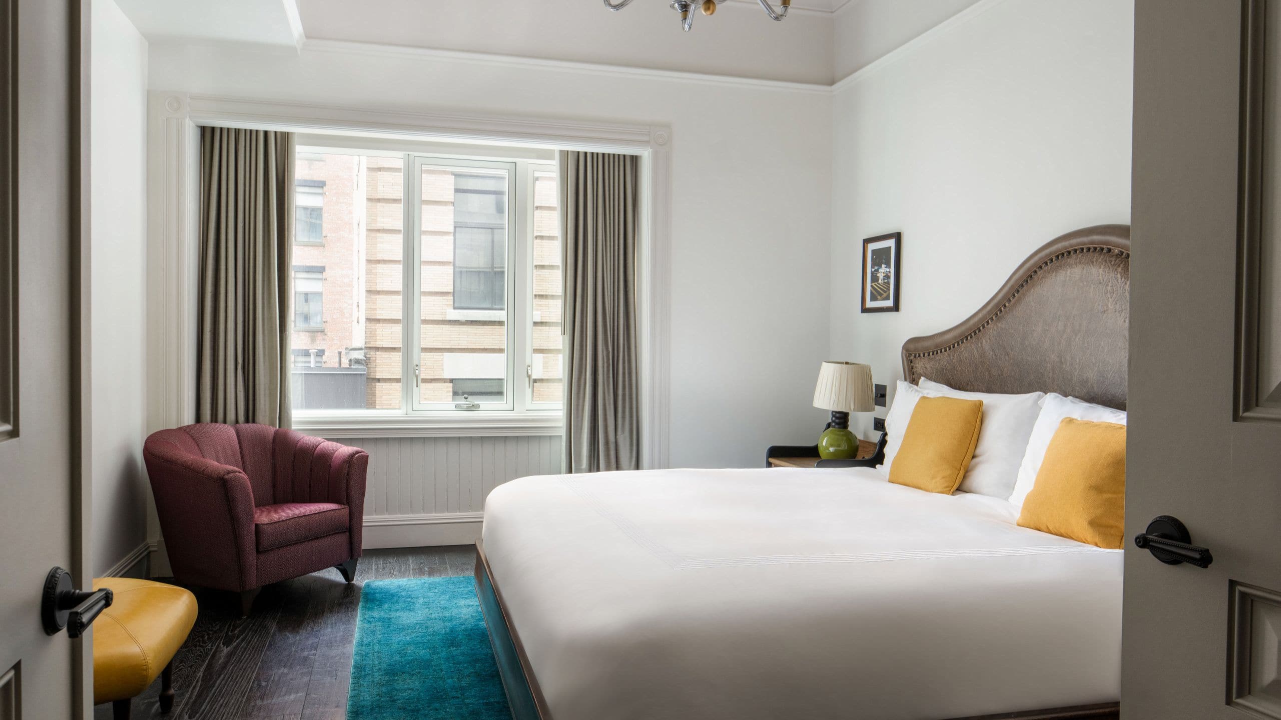 One bedroom suite with side chair and a window
